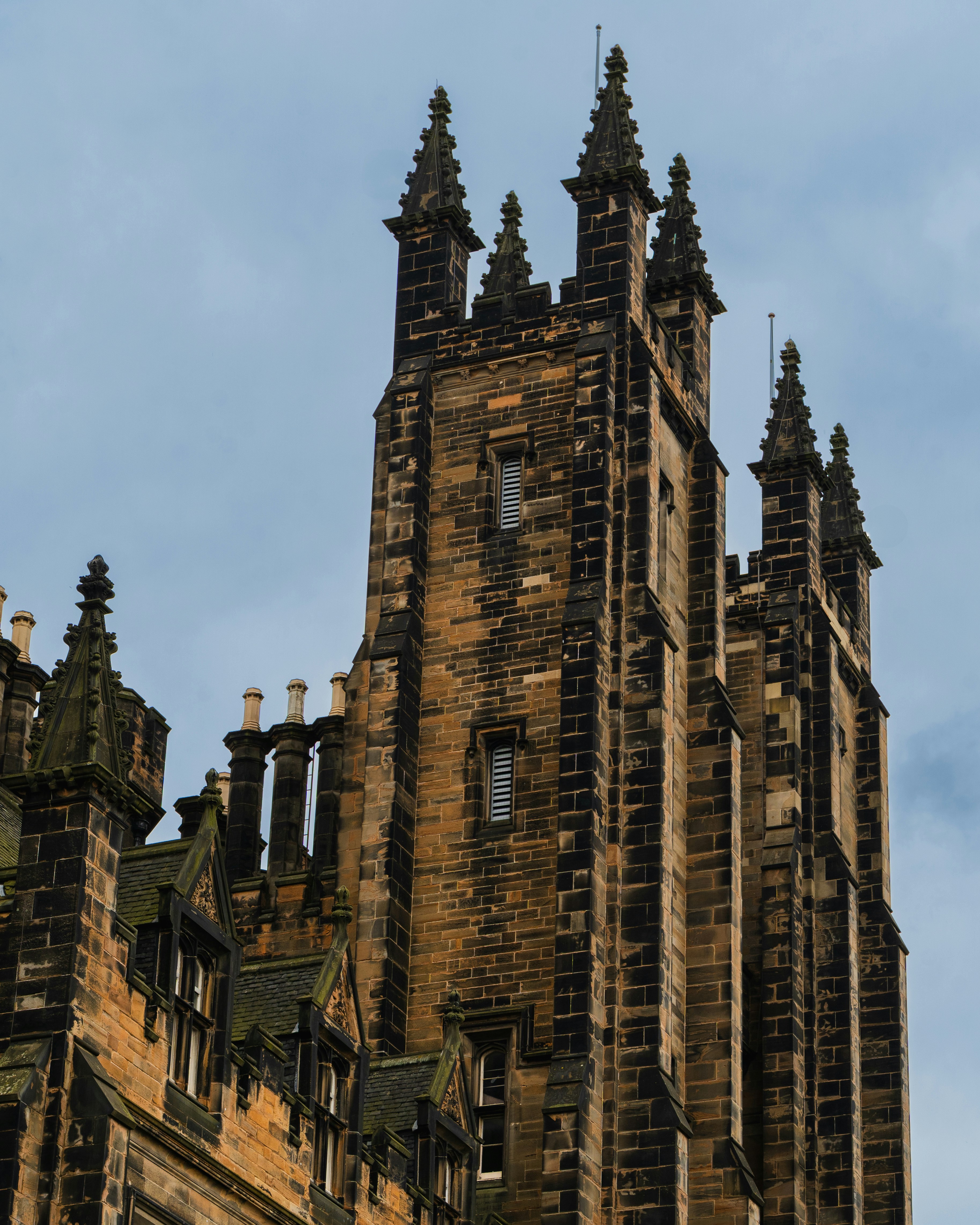 Gothic architecture tower against a cloudy sky