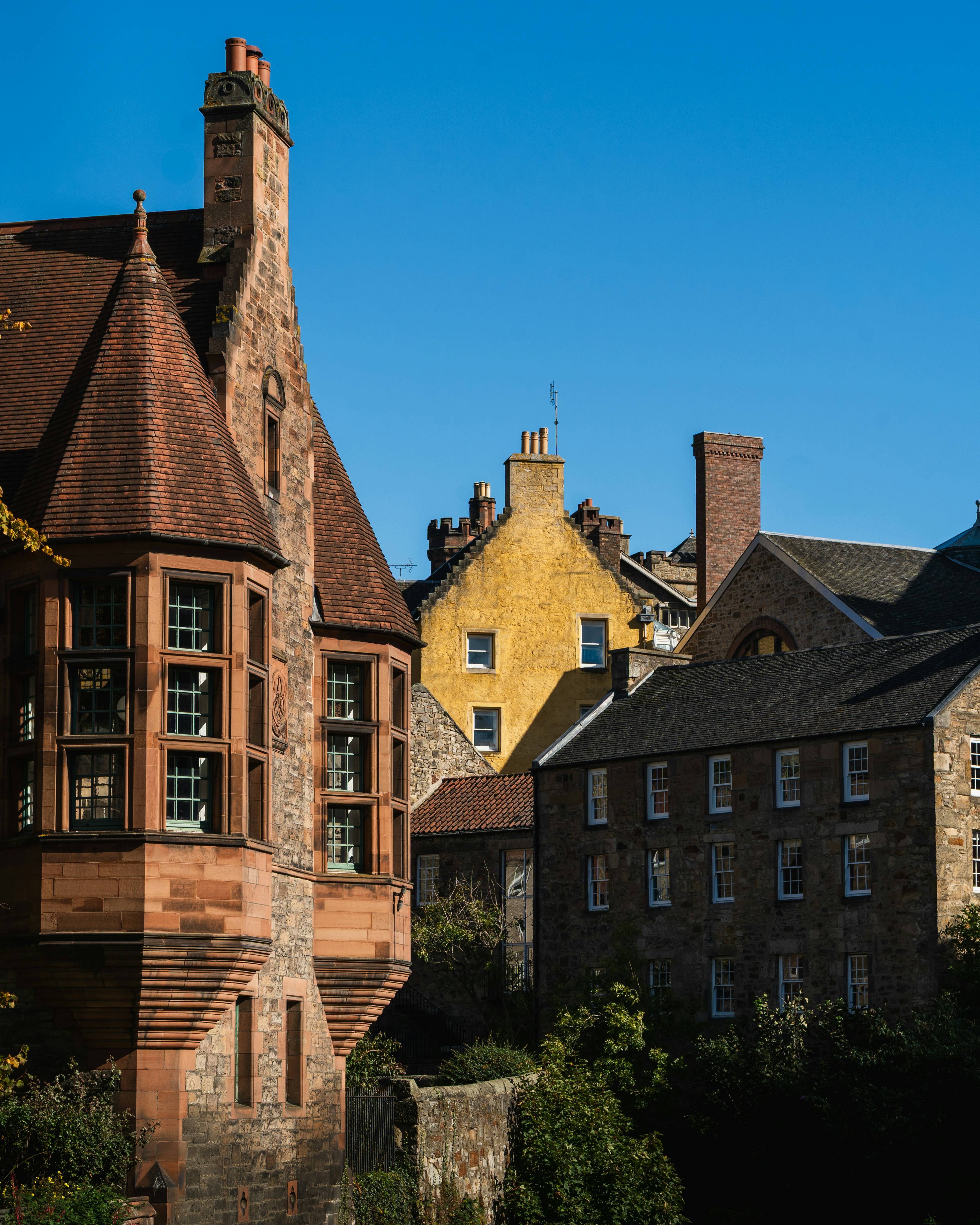 Historic stone buildings under a clear blue sky.