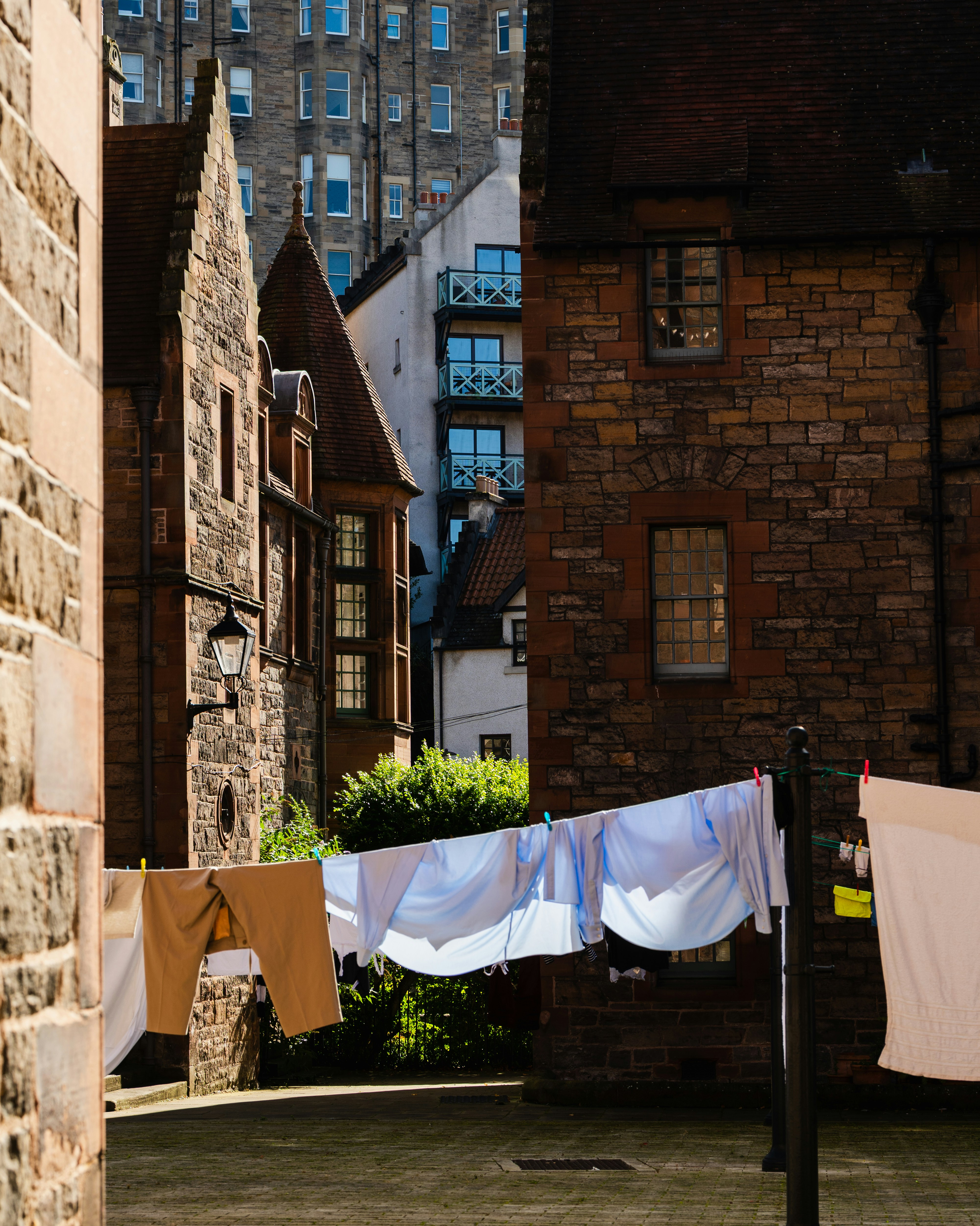 Laundry drying on a clothesline between buildings.