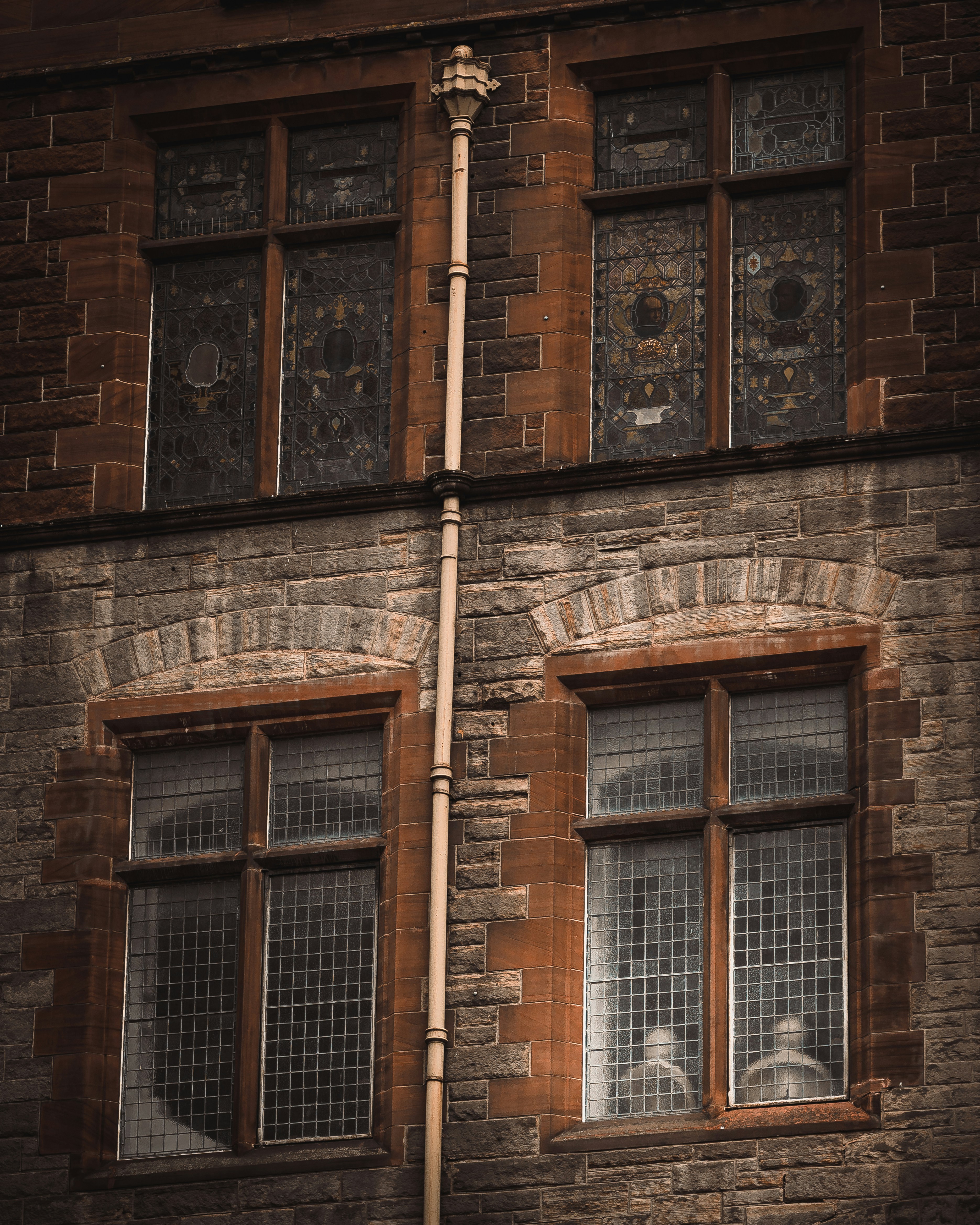 Old stone building with leaded glass windows.