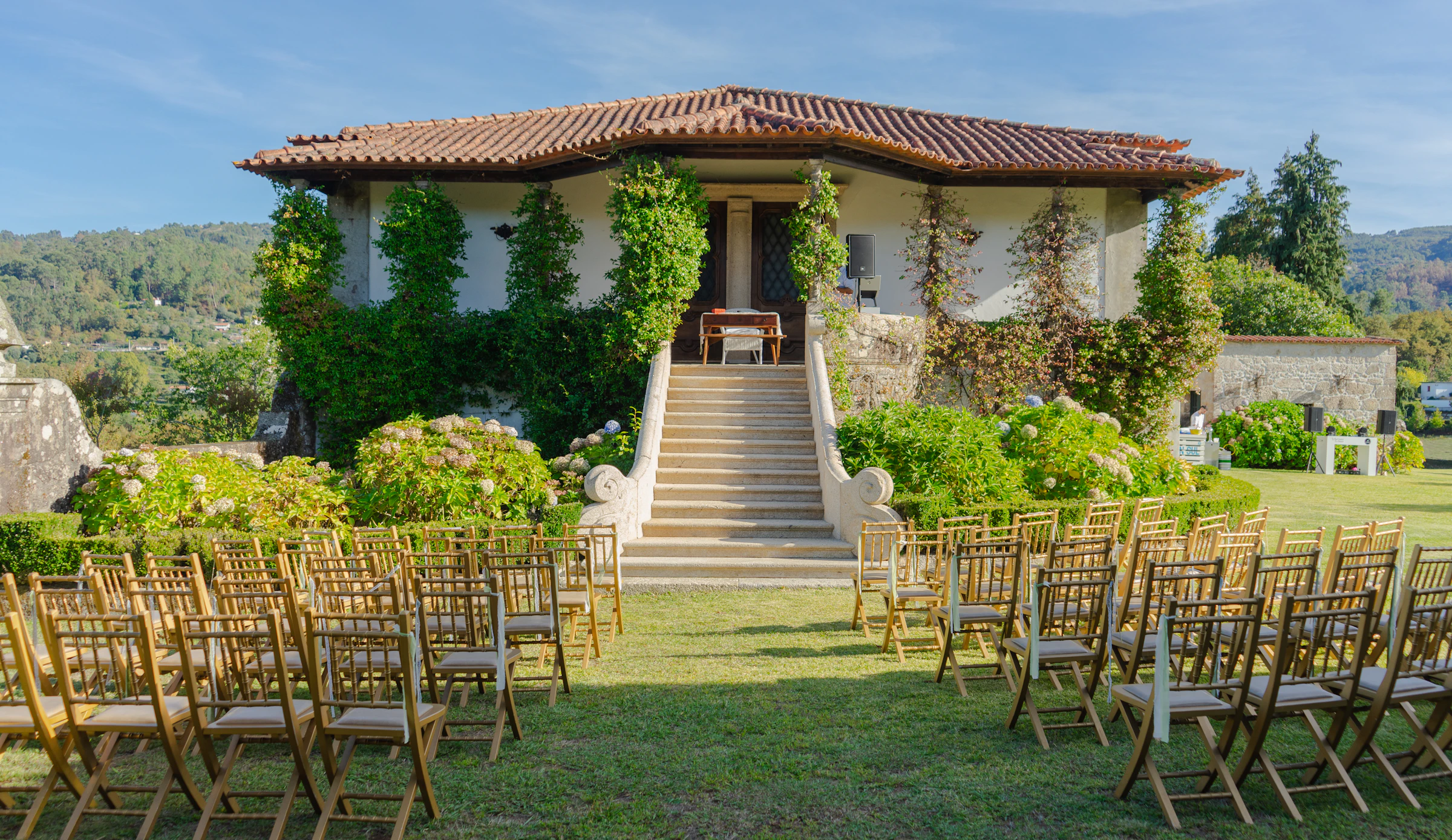 Outdoor wedding ceremony with floral decorations and guest seating