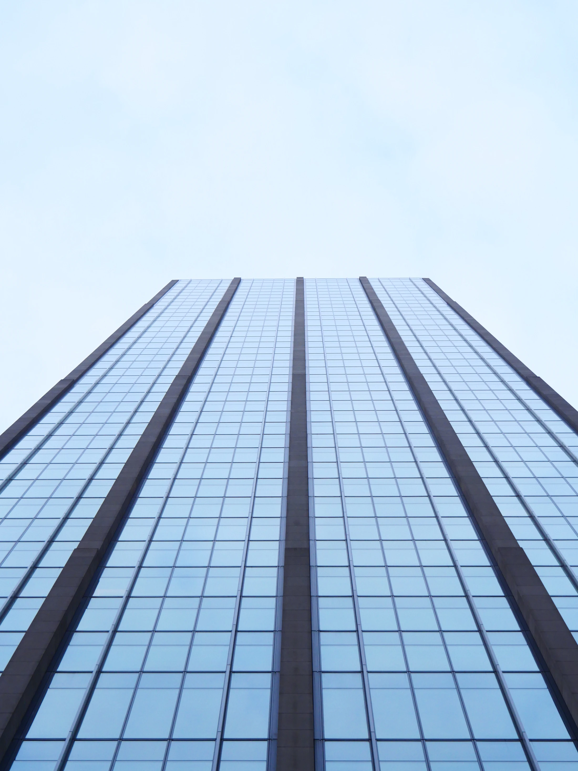 Modern glass skyscraper against the sky