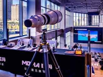 Telephoto lens on tripod at exhibition