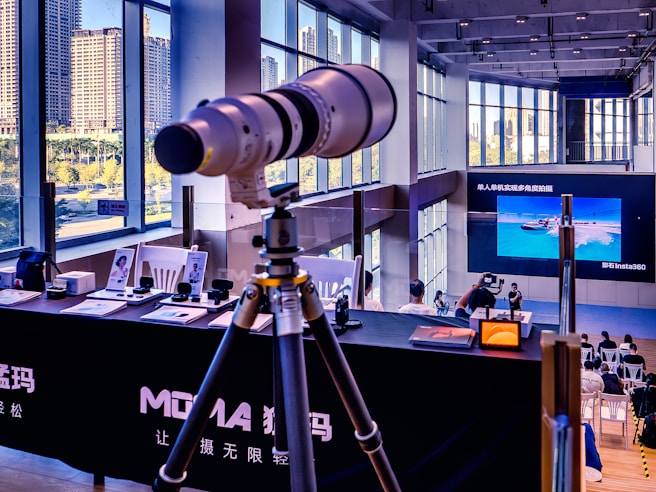 Telephoto lens on tripod at exhibition