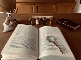Open book with magnifying glass on desk