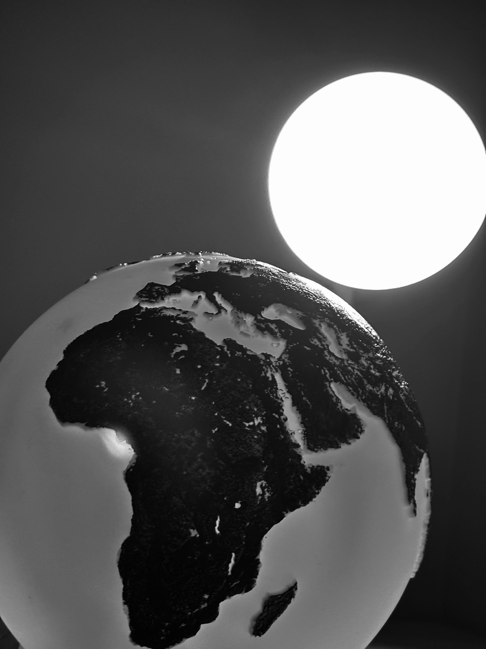 Globe with sun in the background