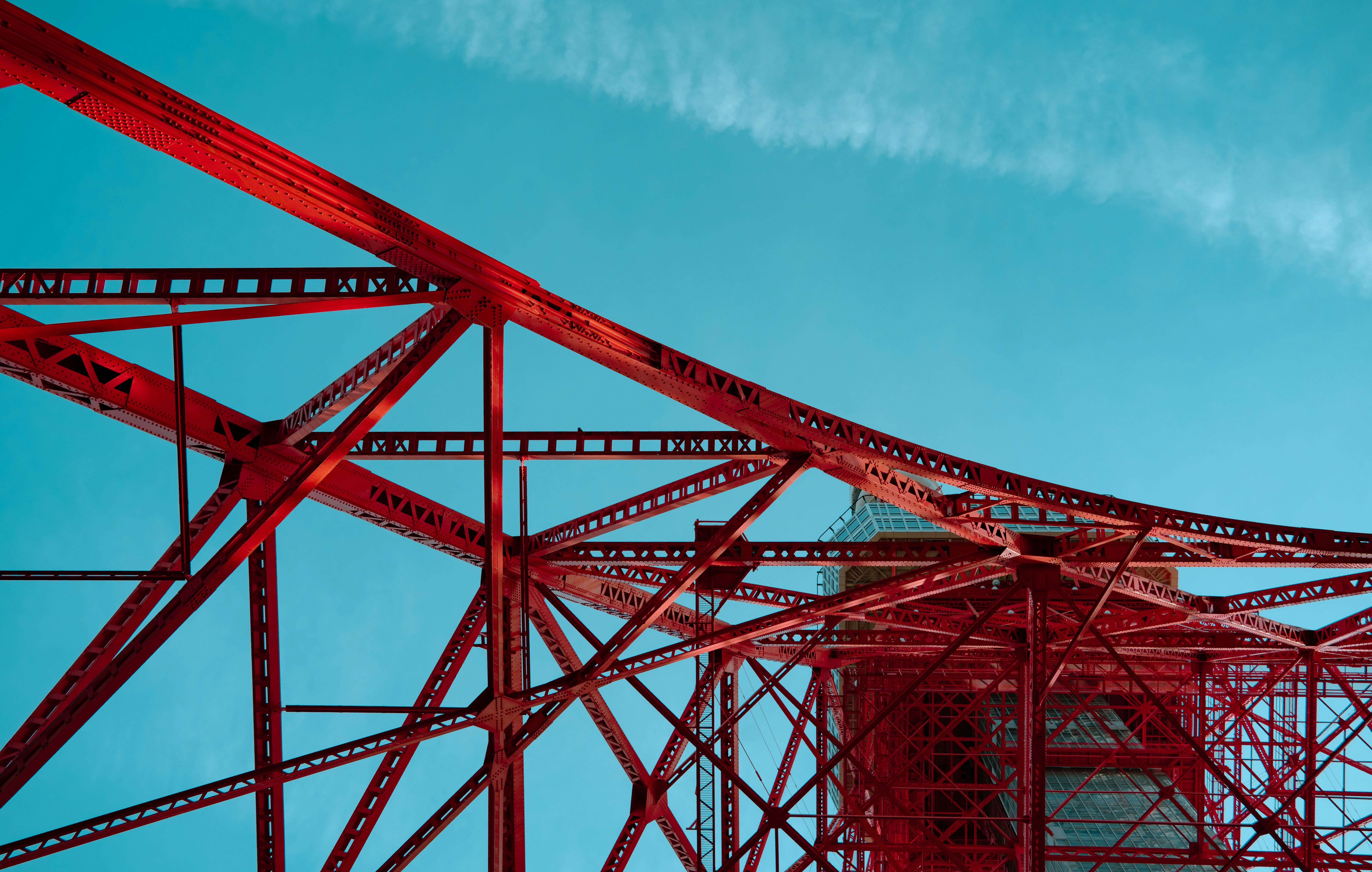 Red steel structure against a bright blue sky