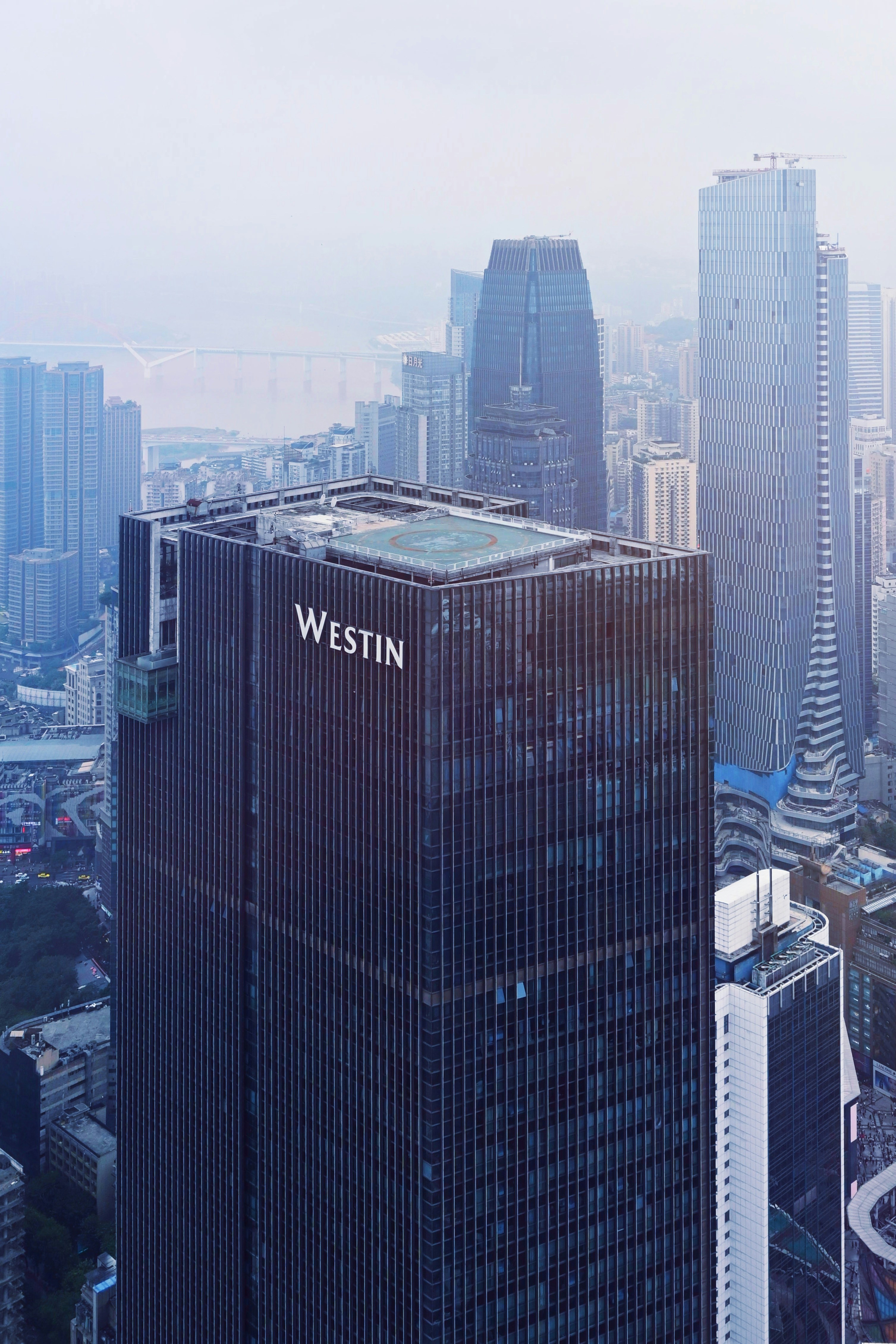 Westin hotel building amidst a hazy cityscape