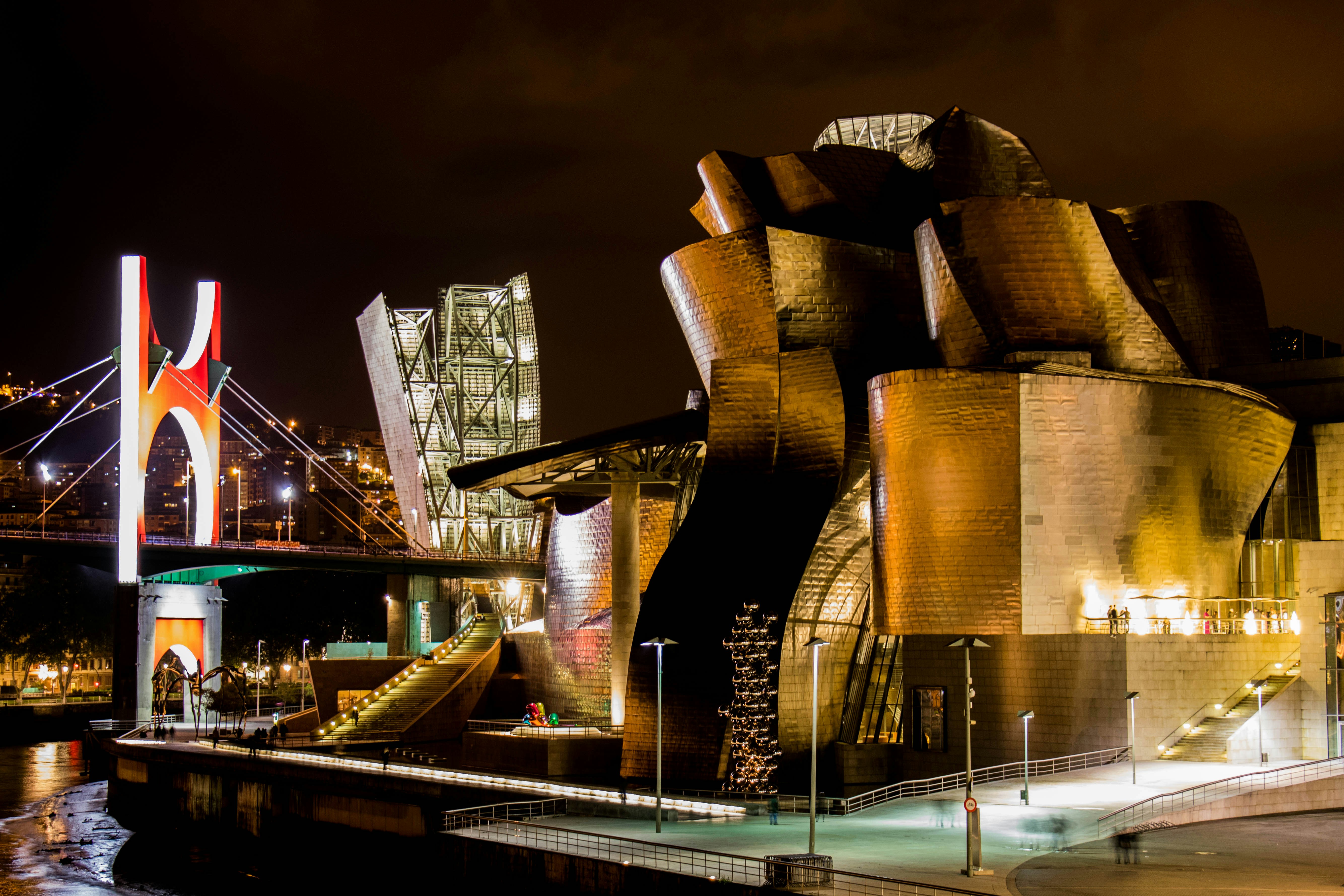 Guggenheim museum bilbao at night with bridge