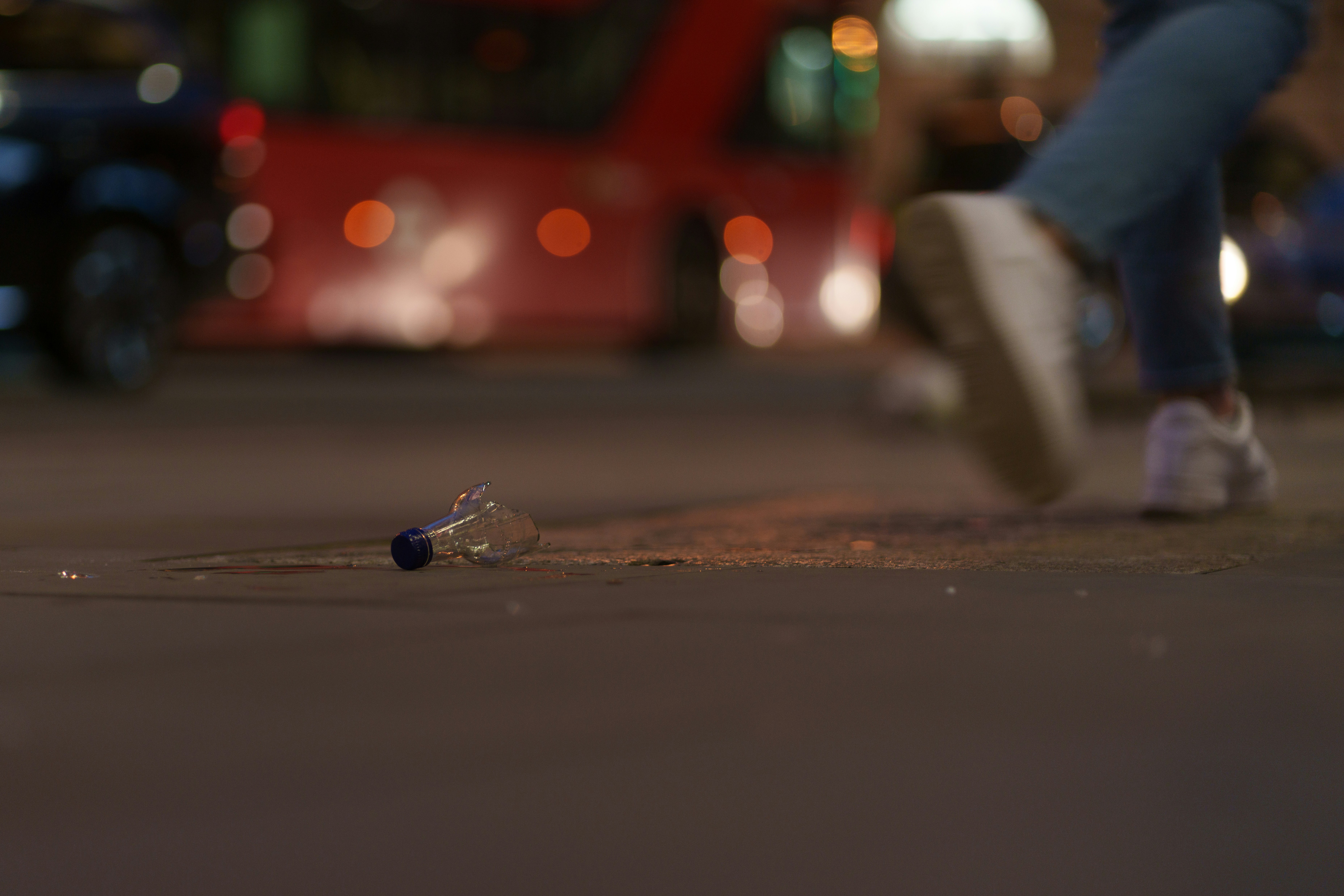 A broken glass bottle on a street at night