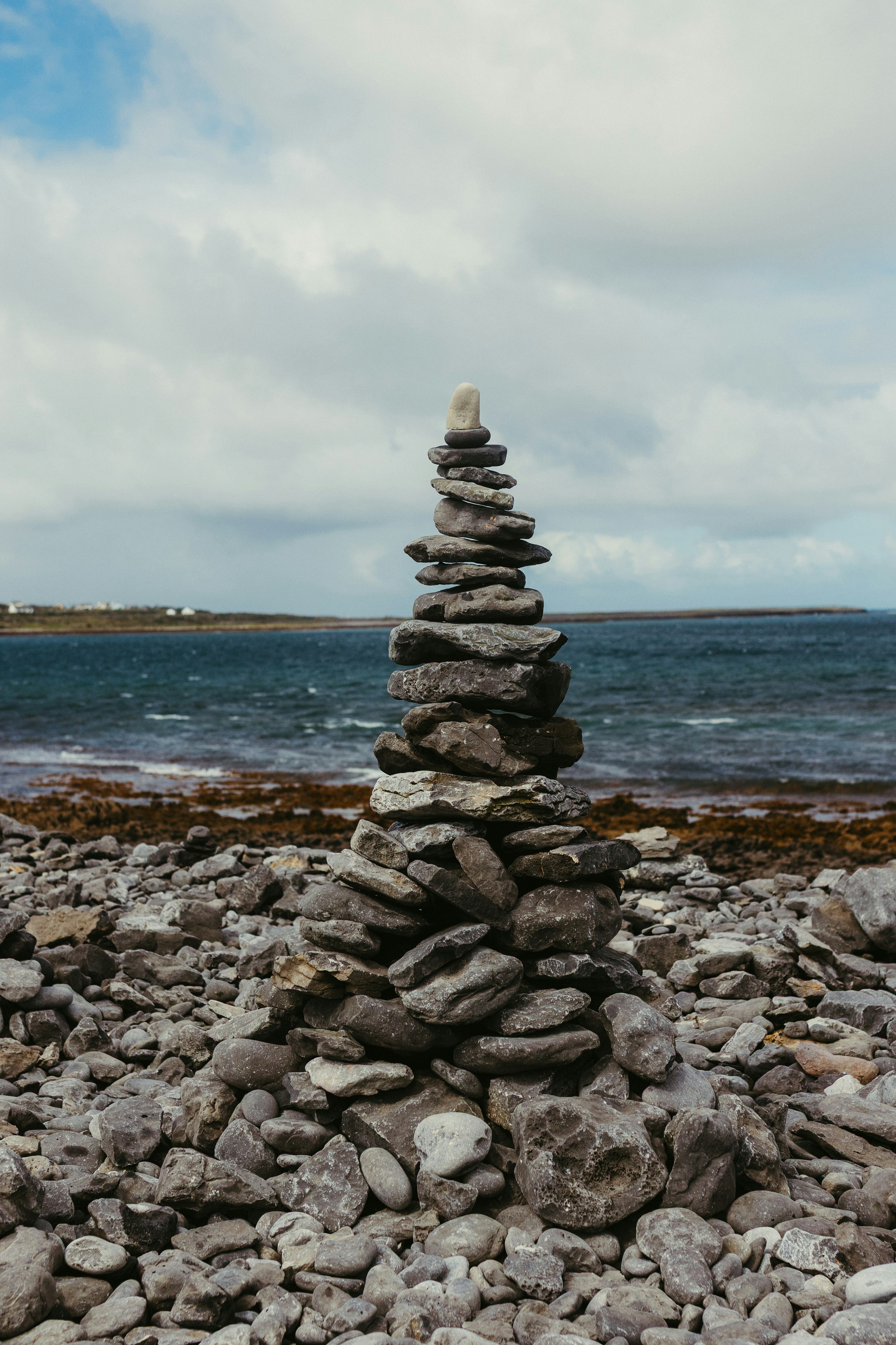 Stack of stones on a rocky shore by the sea