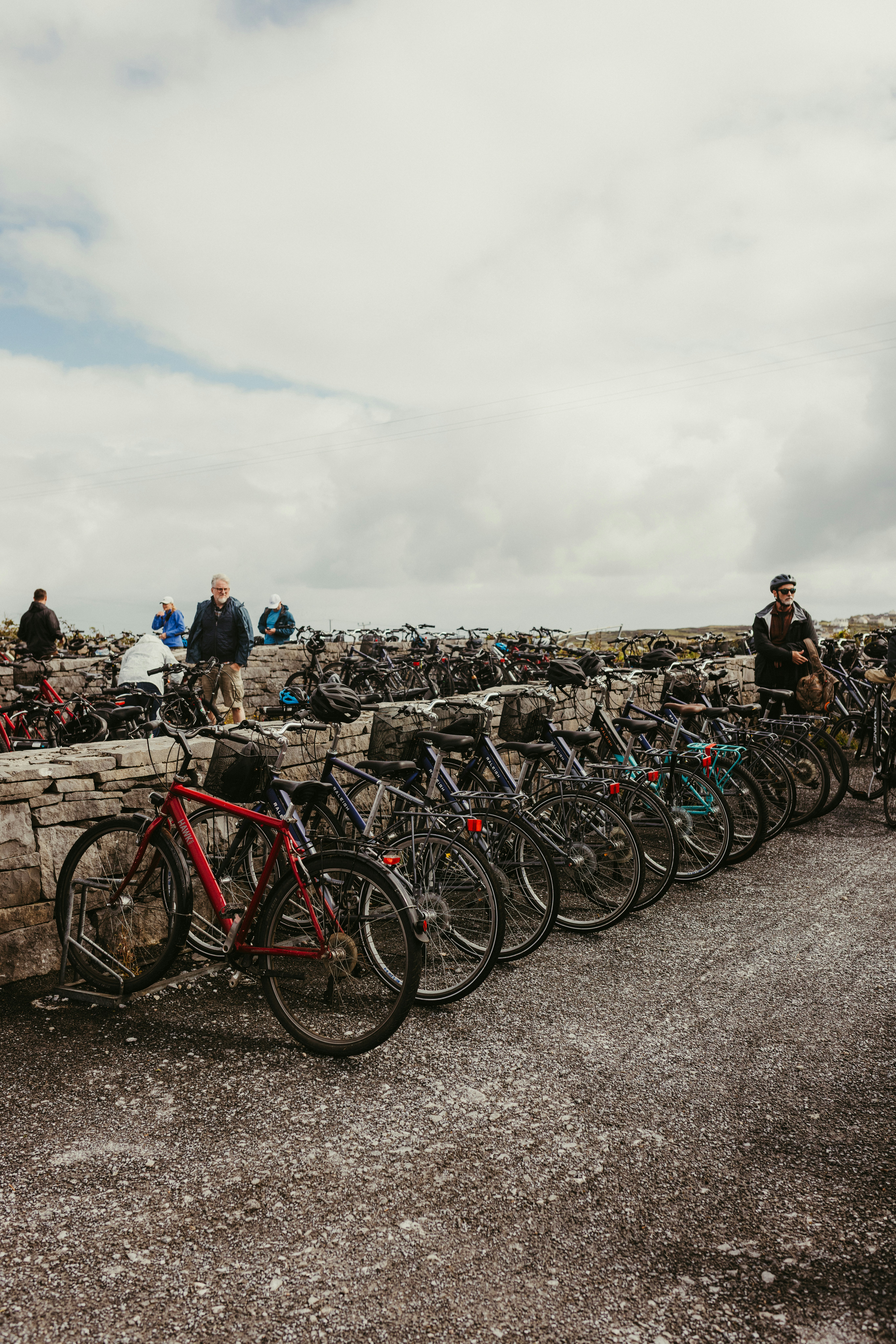 Row of parked bicycles with people in background