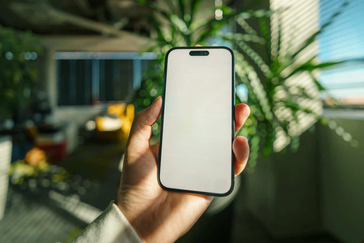 Hand holding a smartphone, representing Android screen recording