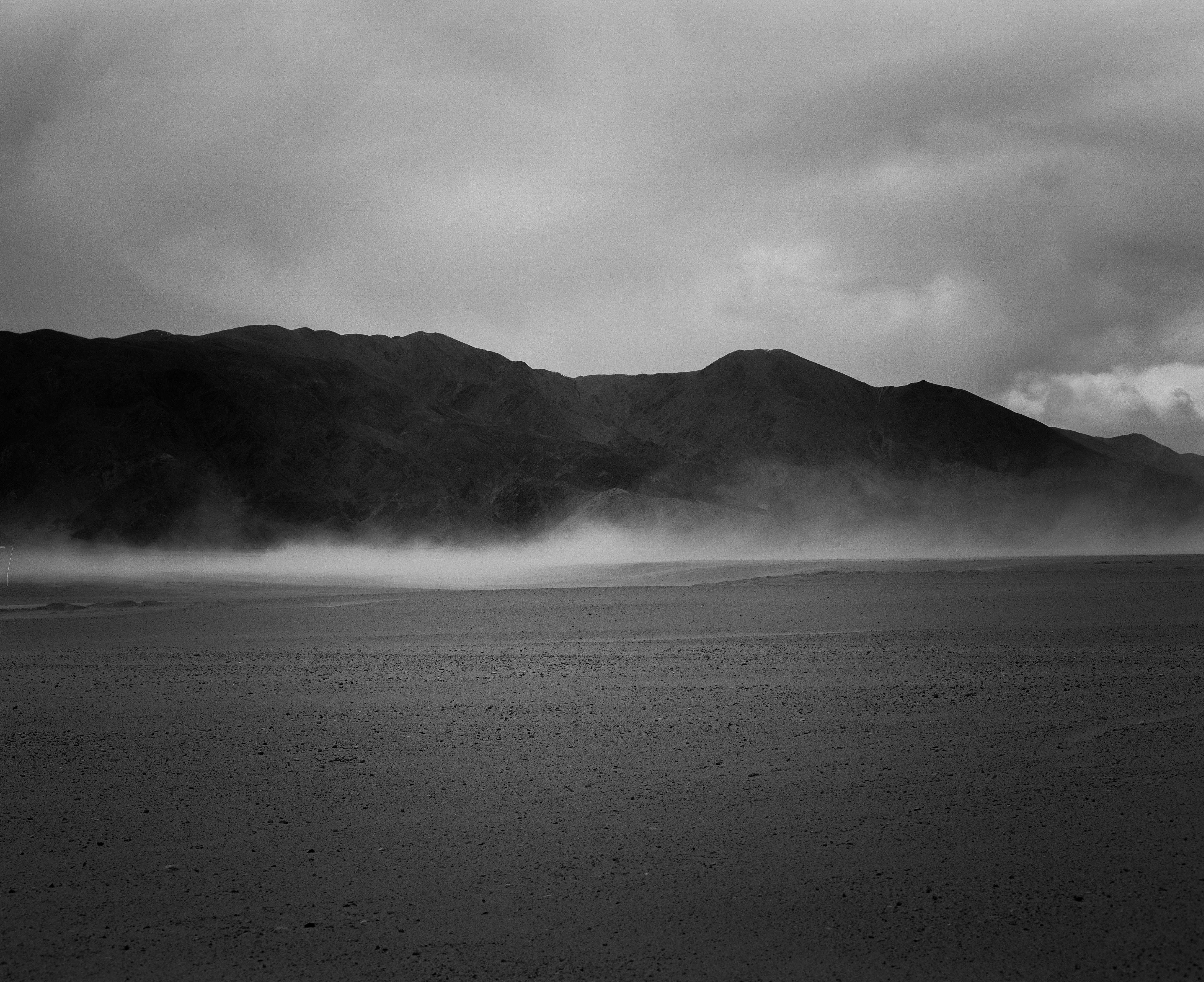 Misty mountains over a barren landscape