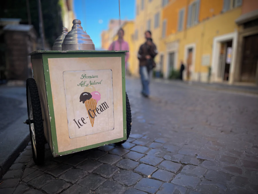 A vending tricycle with a cold box on the front, parked on a cobbled street