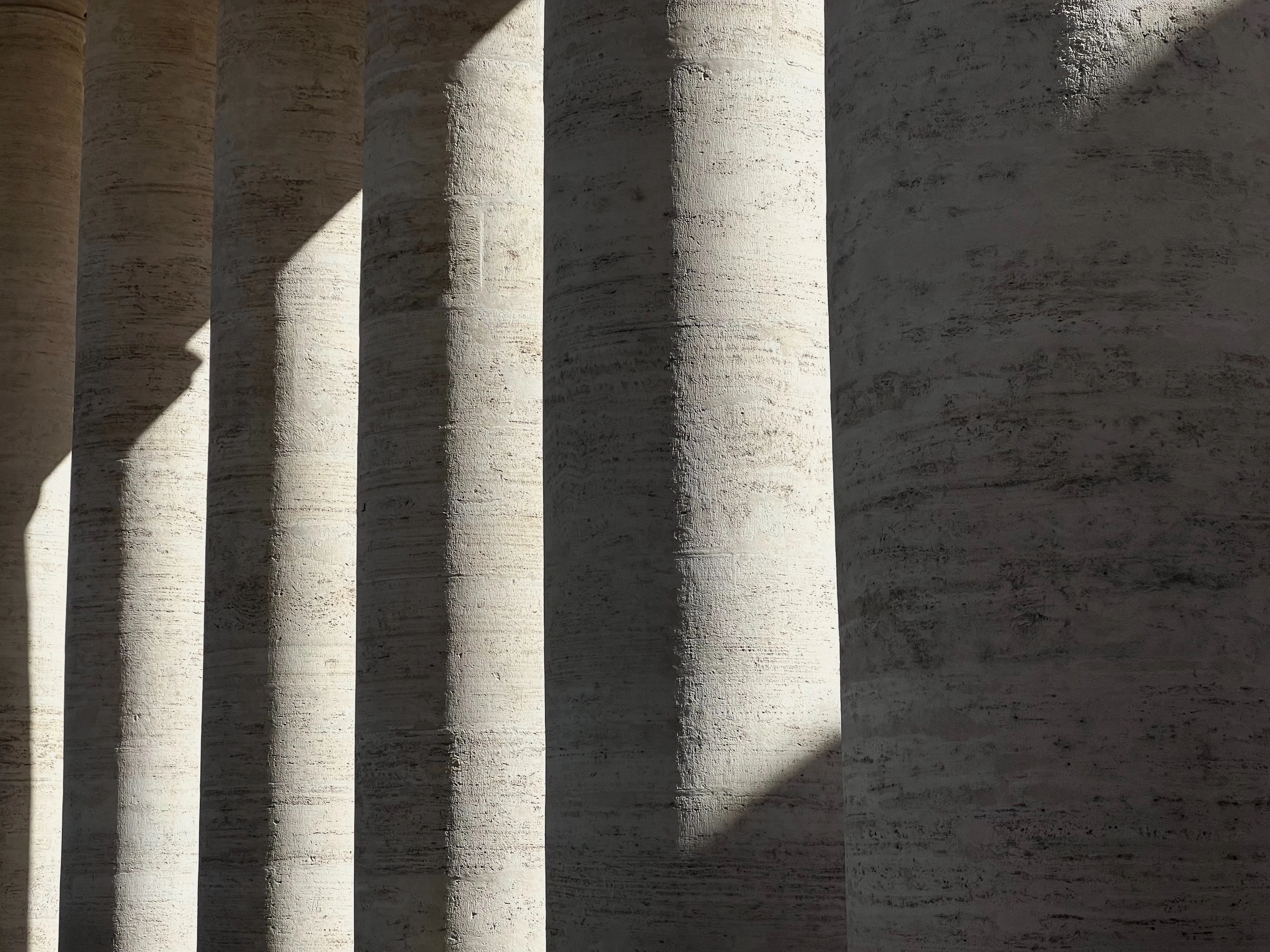 Stone columns casting long shadows in soft afternoon light