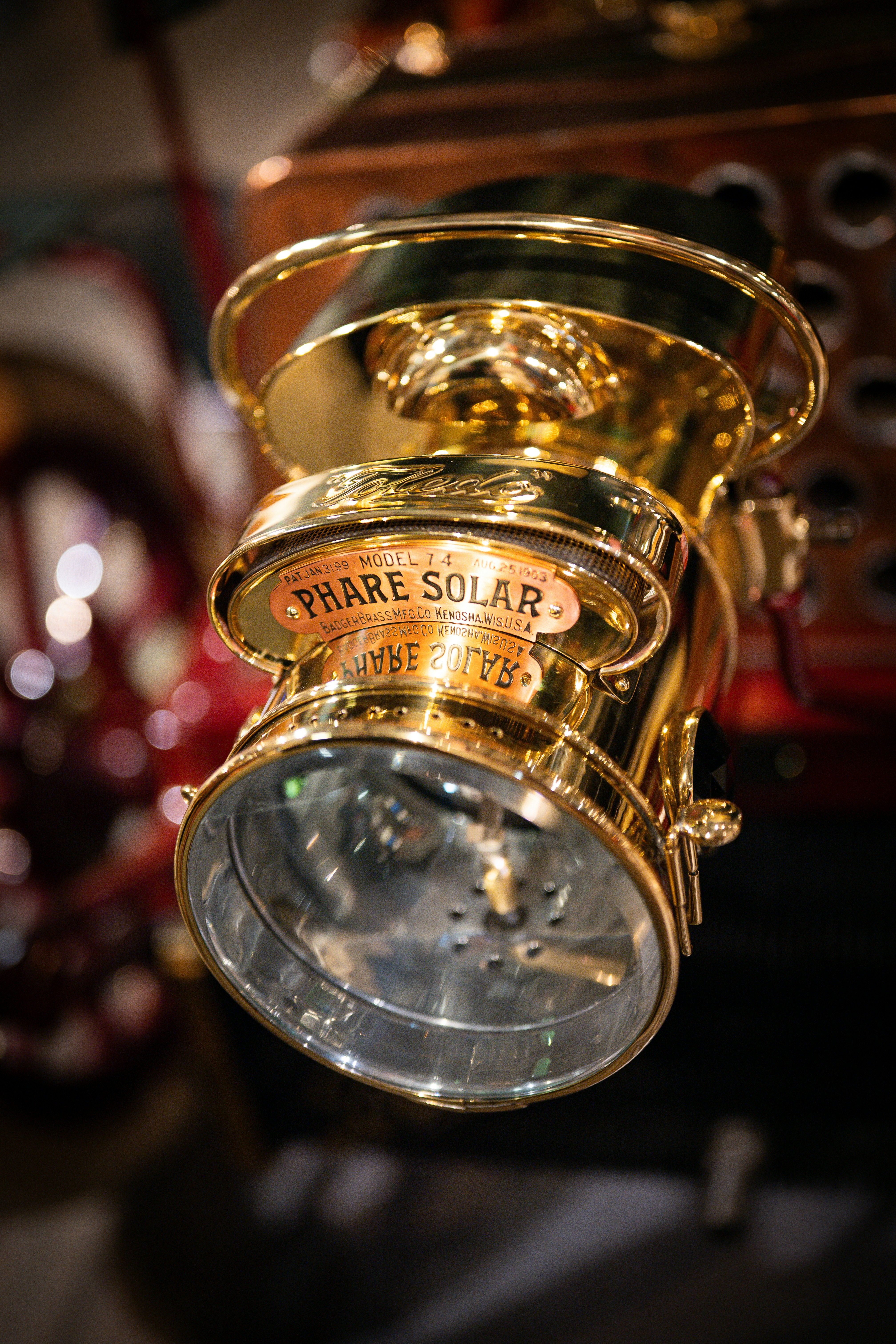 Vintage brass car headlight with 'phare solar' label.