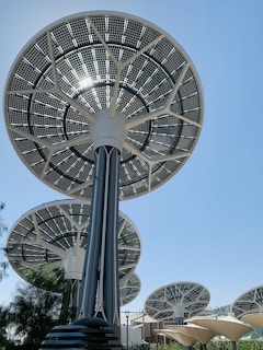 Solar panel trees against a clear blue sky.