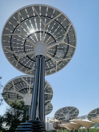 Solar panel trees against a clear blue sky.