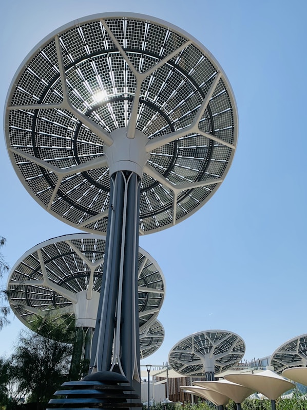 Solar panel trees against a clear blue sky.