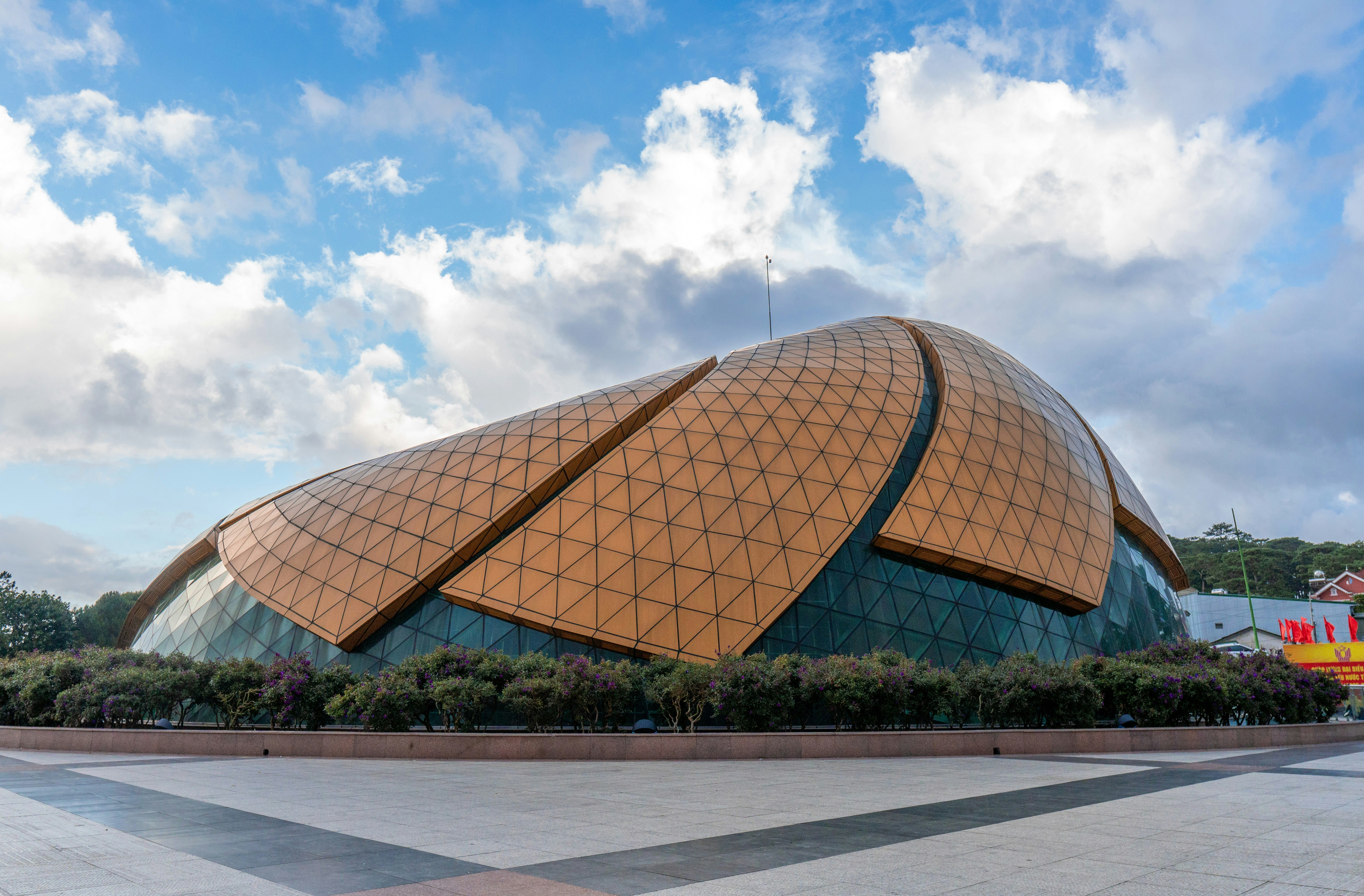 Modern building with a distinctive petal-like roof design.