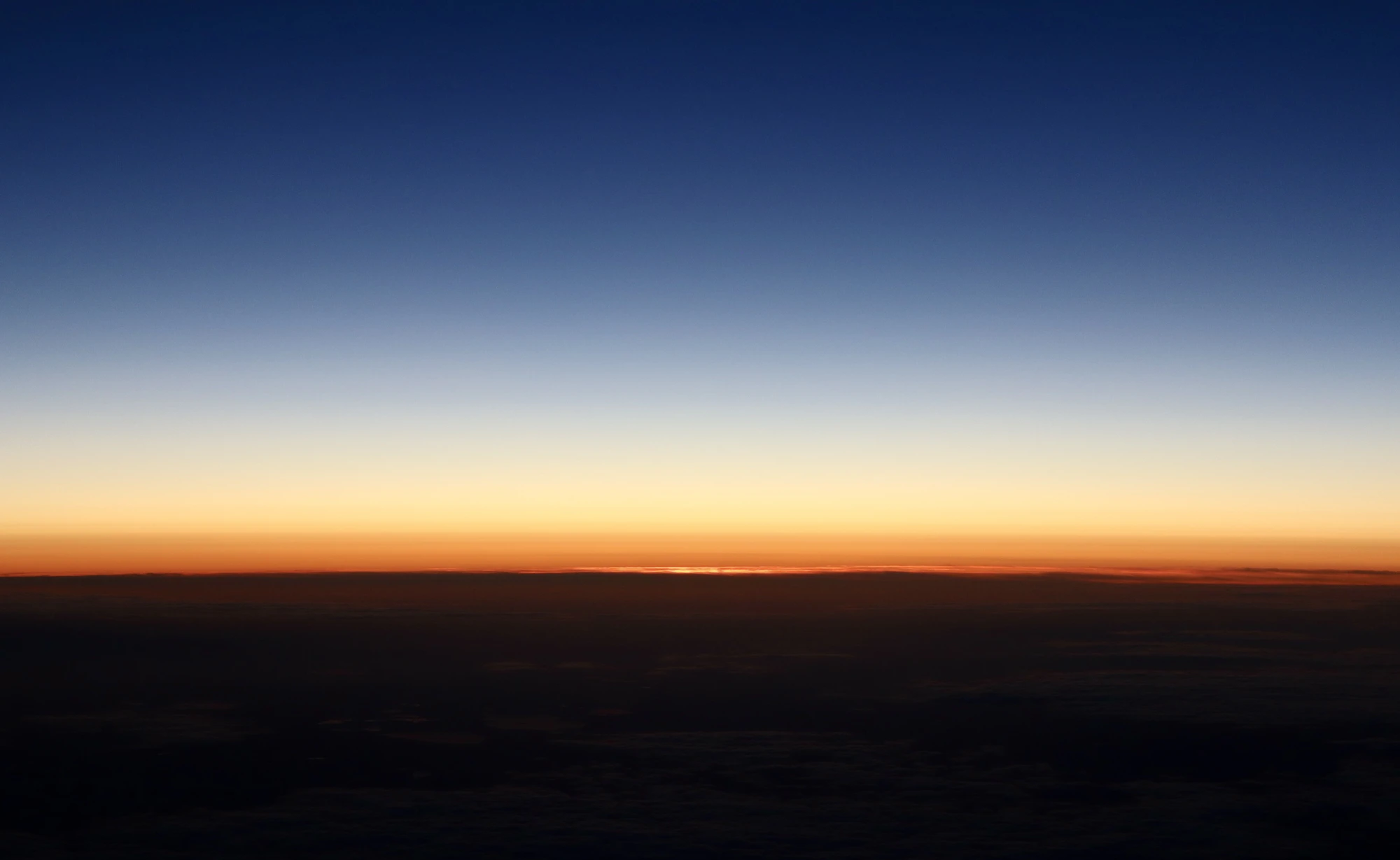 A horizon at sunset under a gradient sky