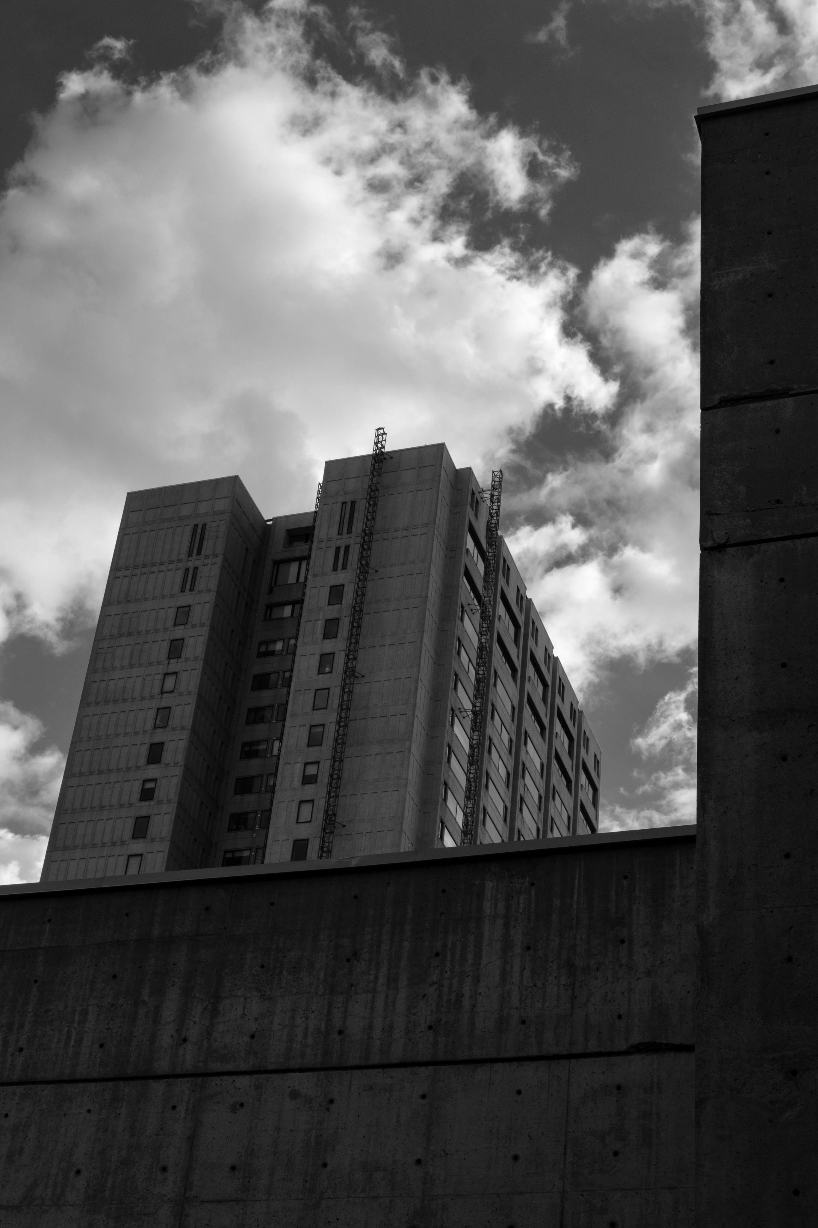 Tall concrete building against a cloudy sky