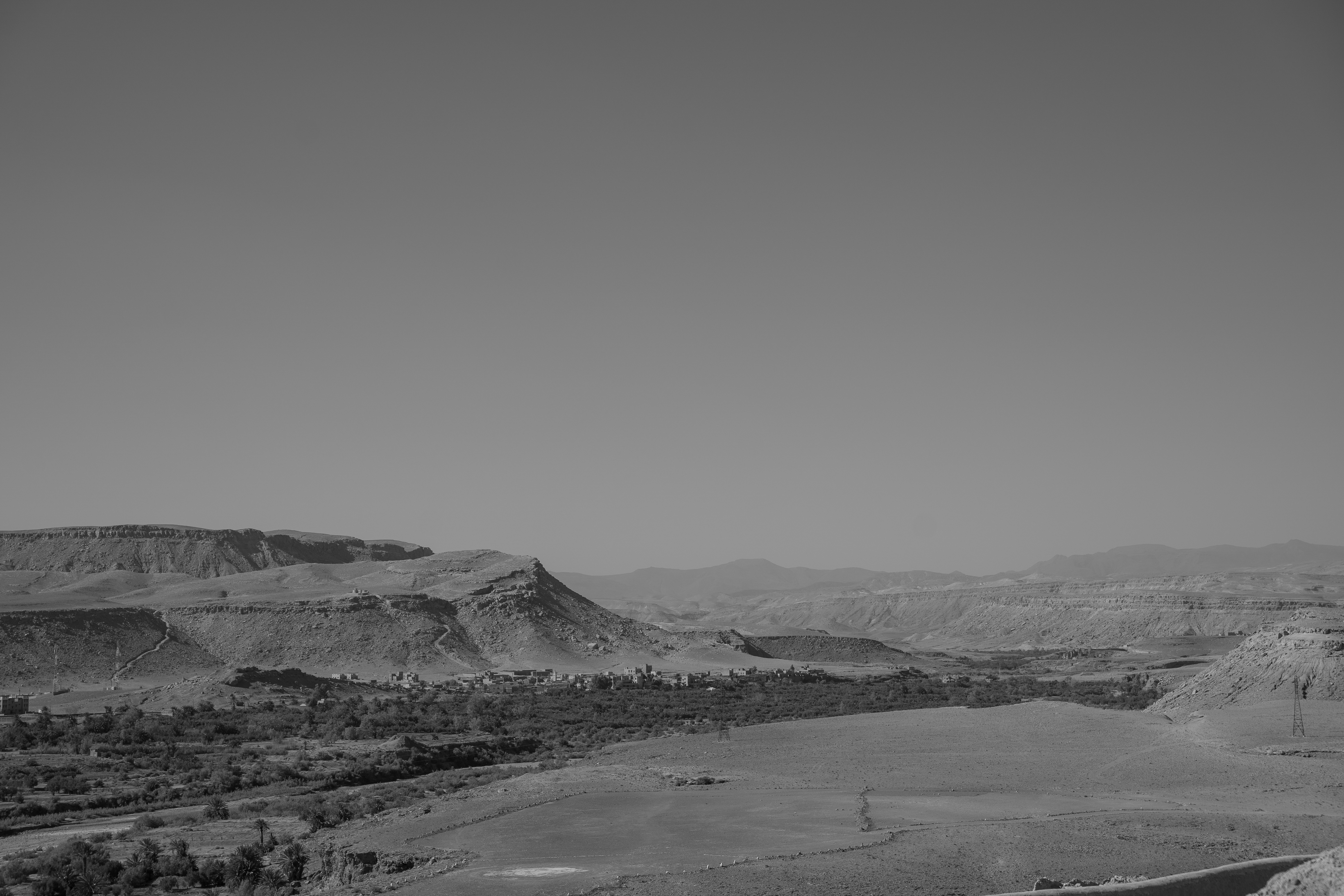 Arid landscape with rolling hills and sparse vegetation