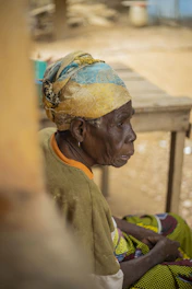 Elderly woman wearing a headscarf and colorful clothing