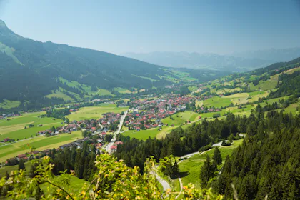 Green valley with a small town and hills