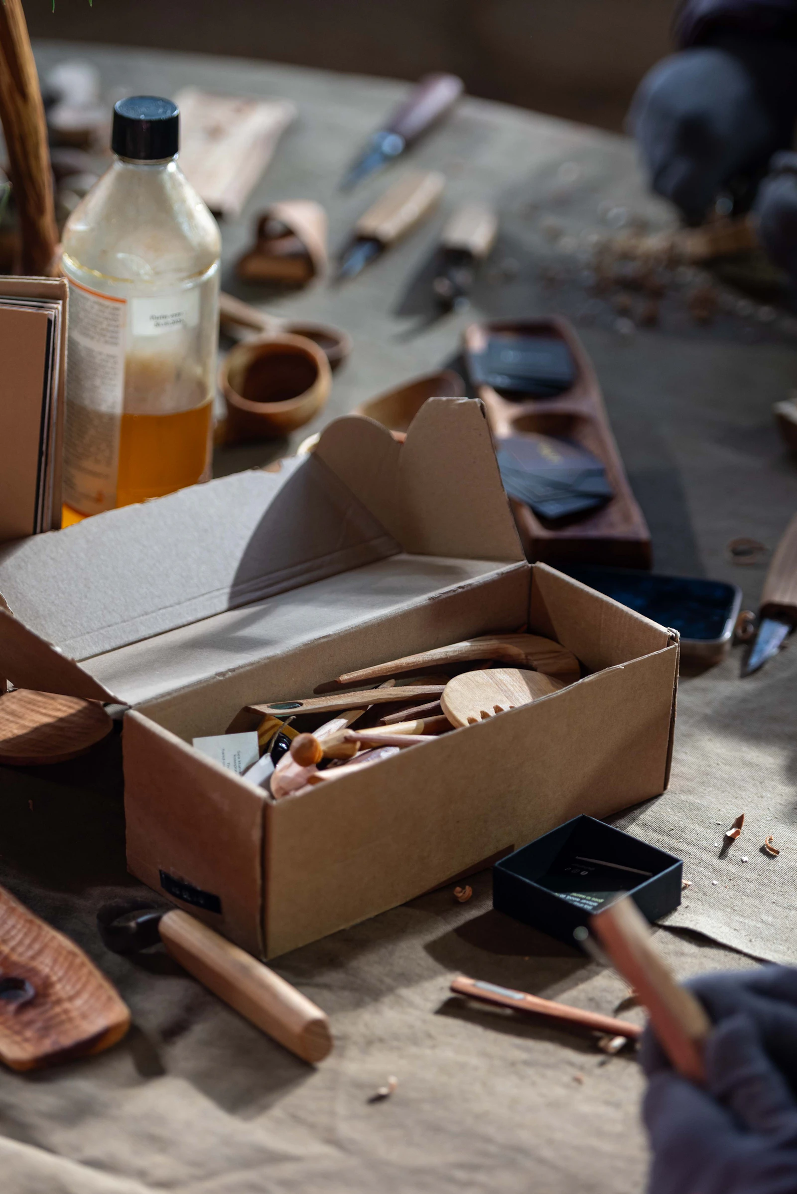 Wood carving tools and supplies on a work table. Photo by Sander Hallaste on Unsplash.