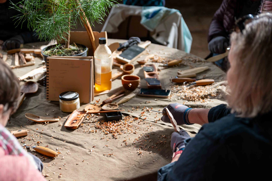 A group carving wood together around a workshop table