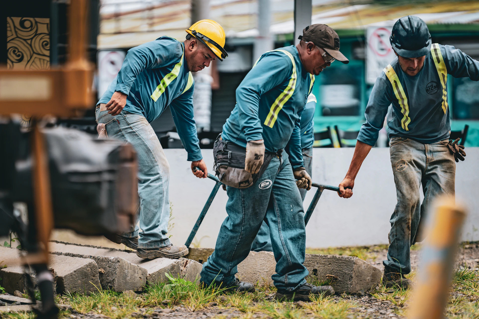 Construction workers laying down railroad tracks together.