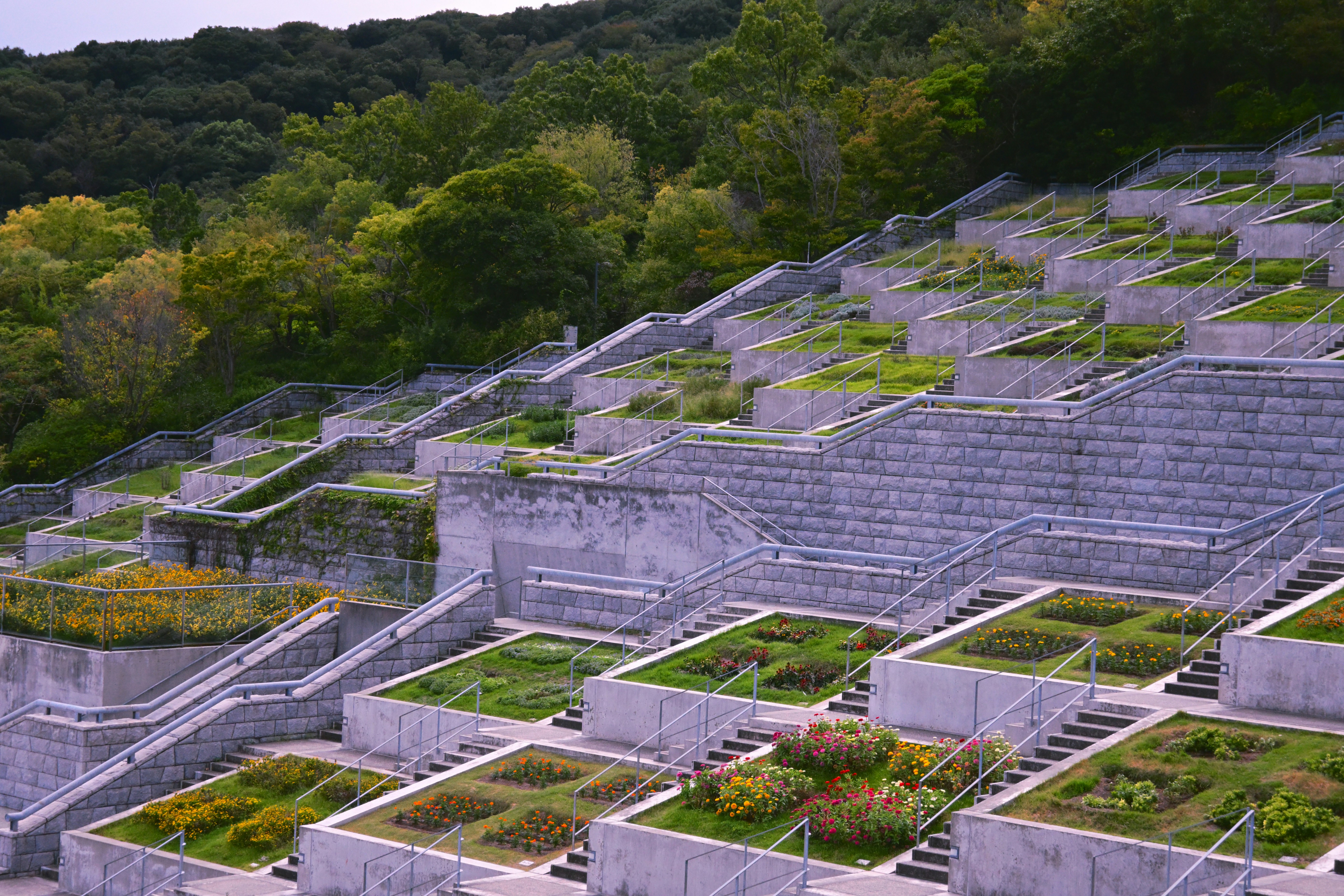 multi-tiered terraced retaining wall with integrated steps and plantings - retaining wall flower bed