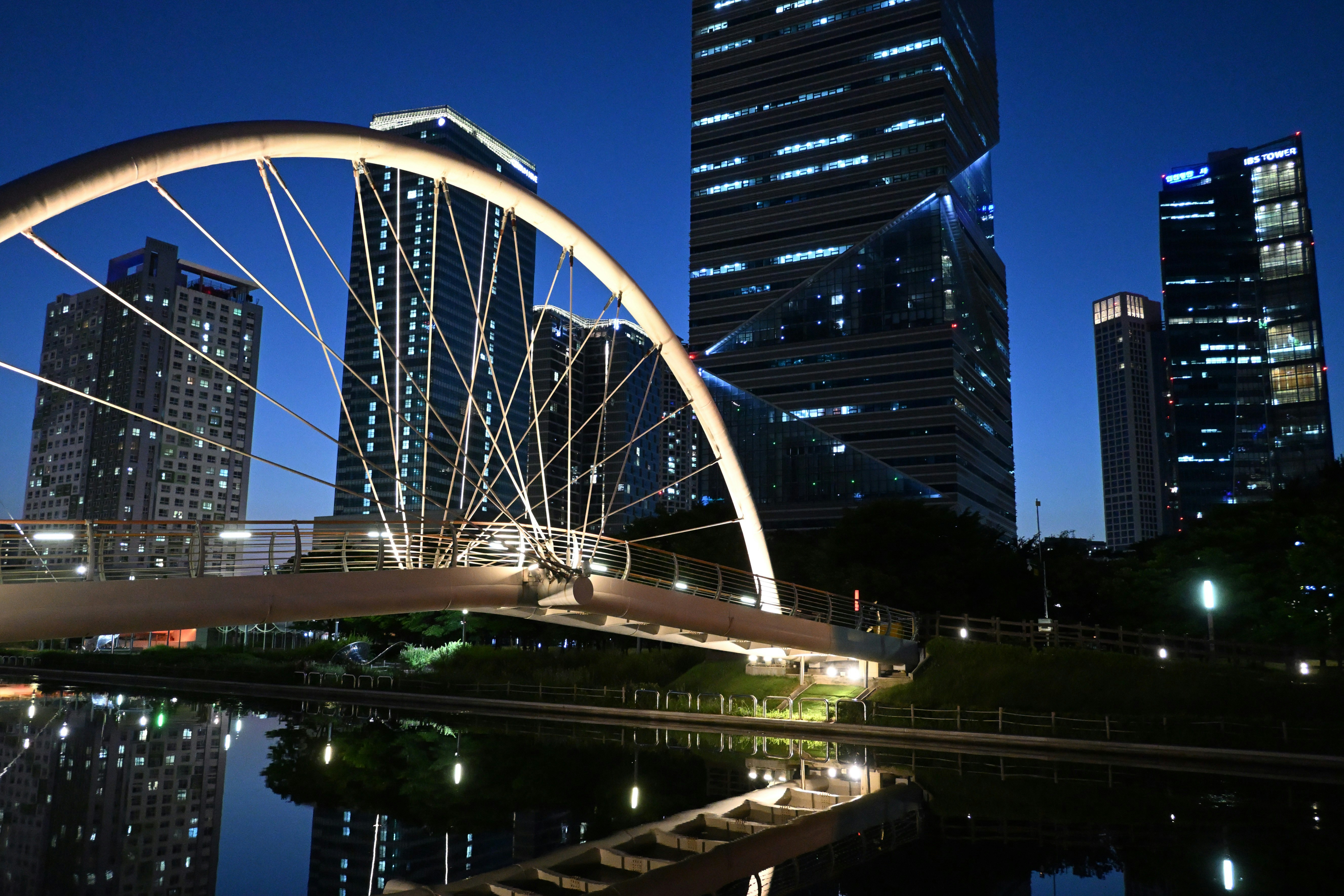 Modern bridge and illuminated skyscrapers at night