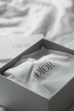 Dior logo on white fabric inside a box