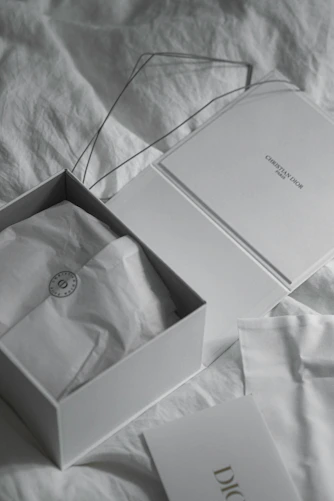 Open white box with dior packaging inside