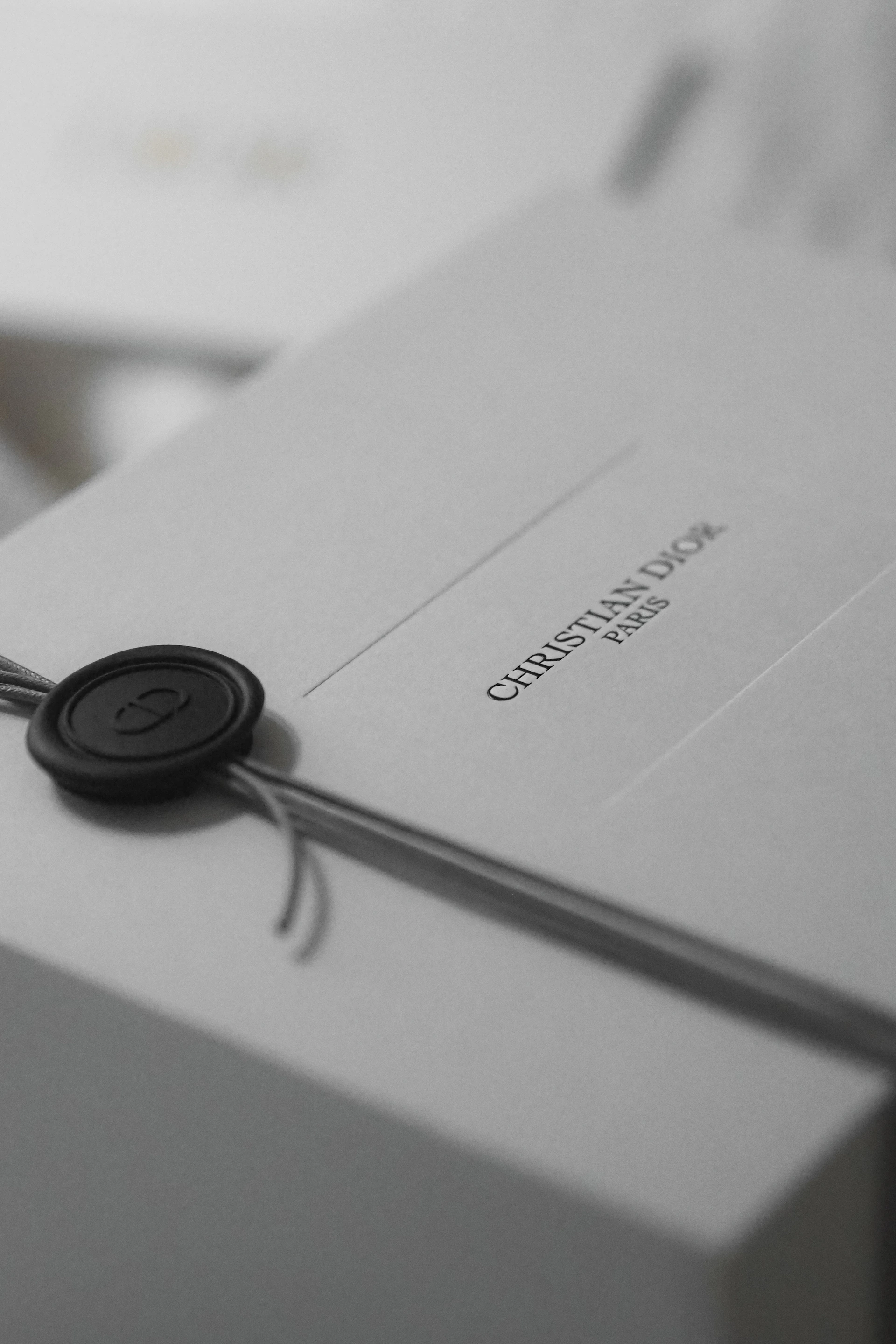 White dior gift box with black wax seal