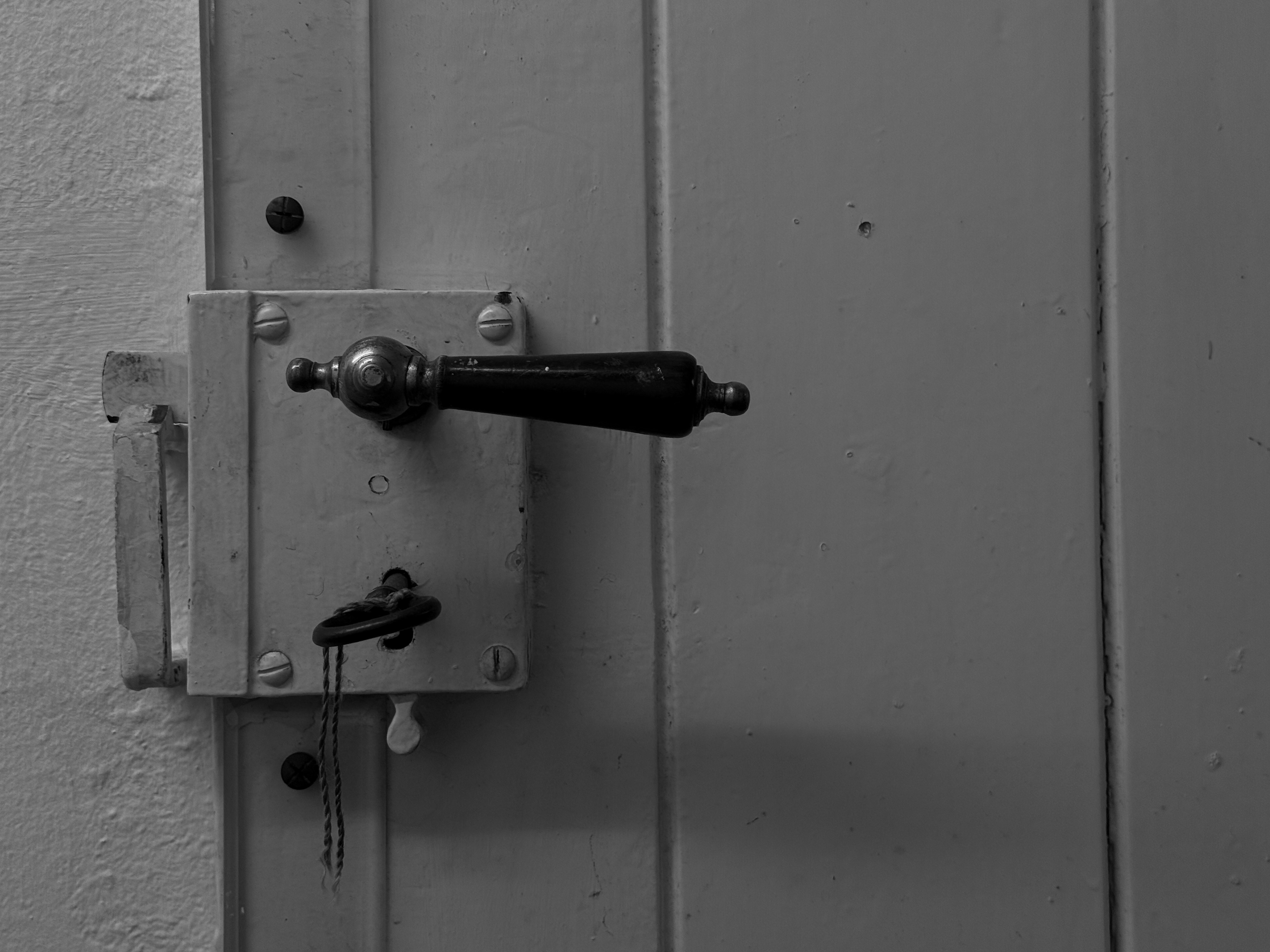 Close-up of an old door handle and lock with key
