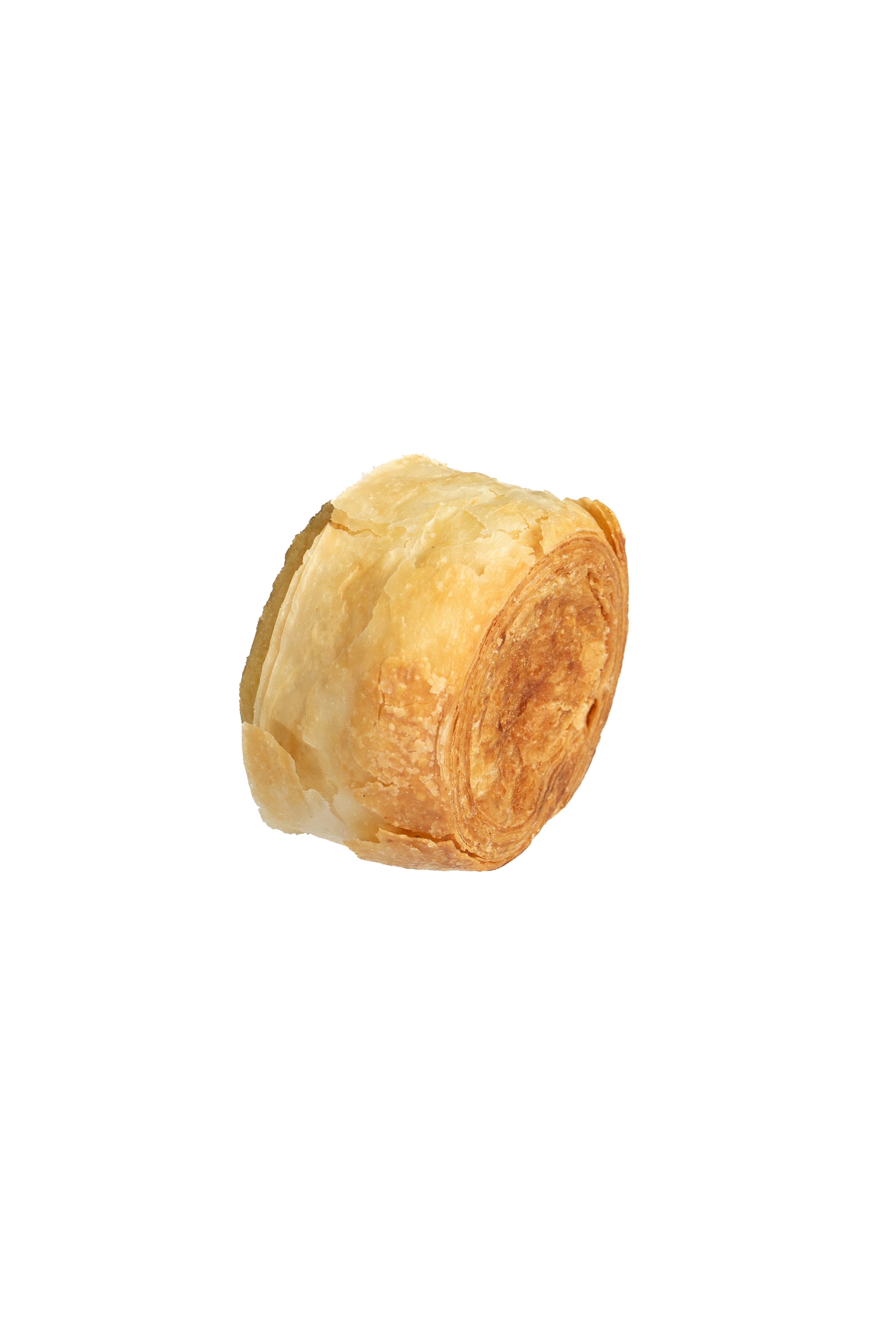 A single golden brown pastry roll on white.