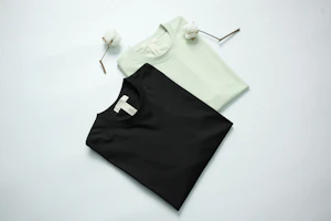 Two t-shirts, black and light green, with cotton stems.