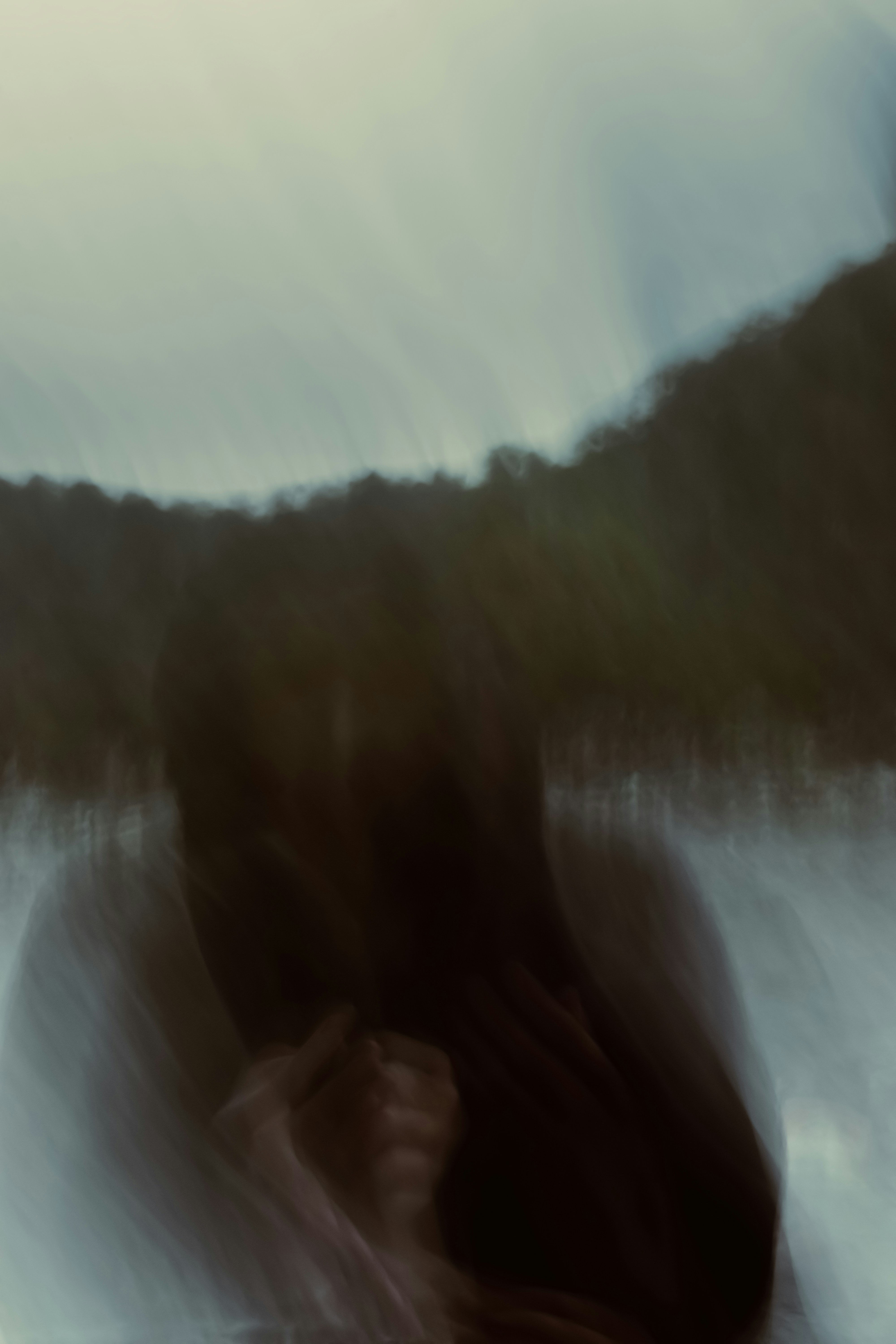 Abstract blurry figure in dark tones