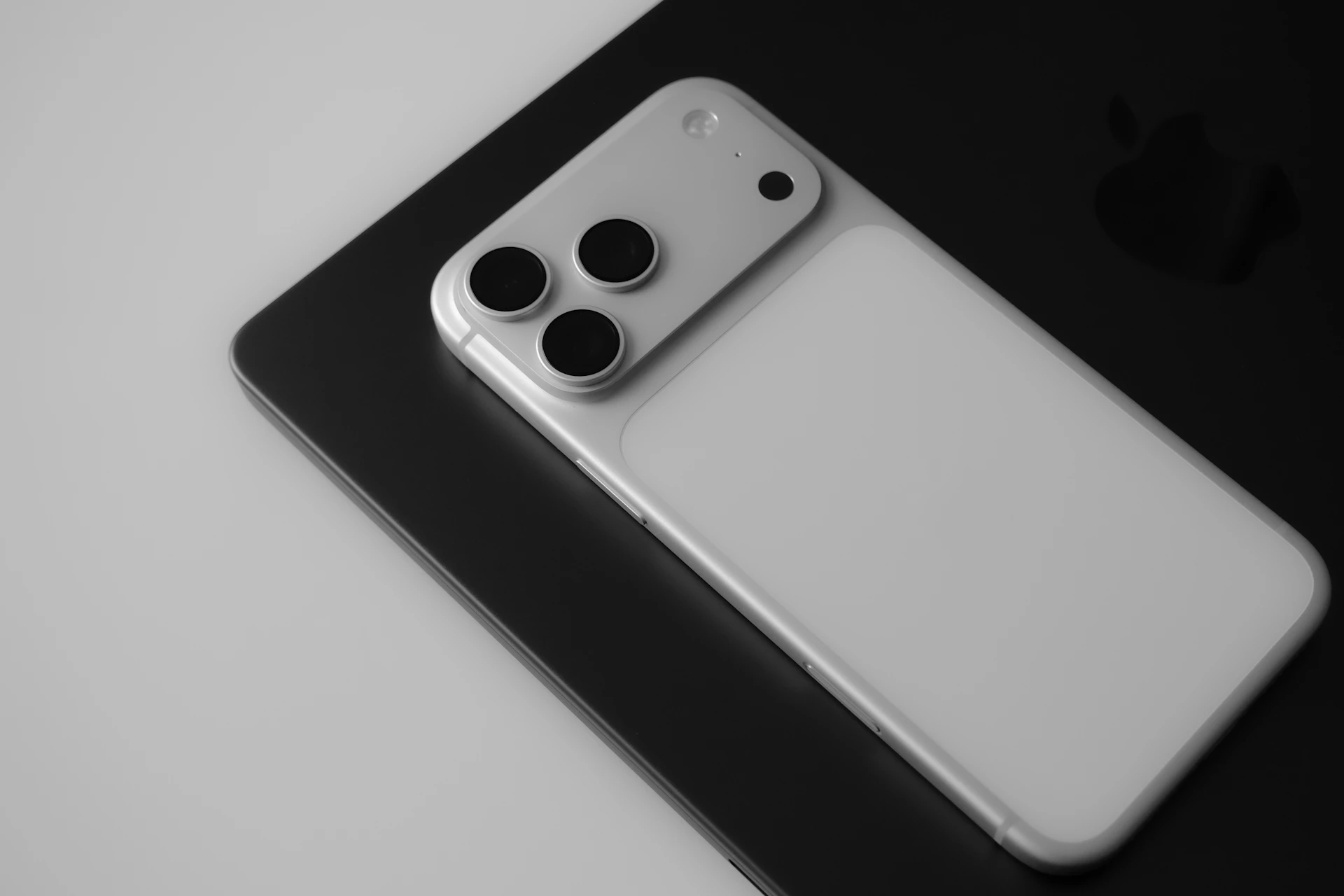 White smartphone with three cameras on dark background