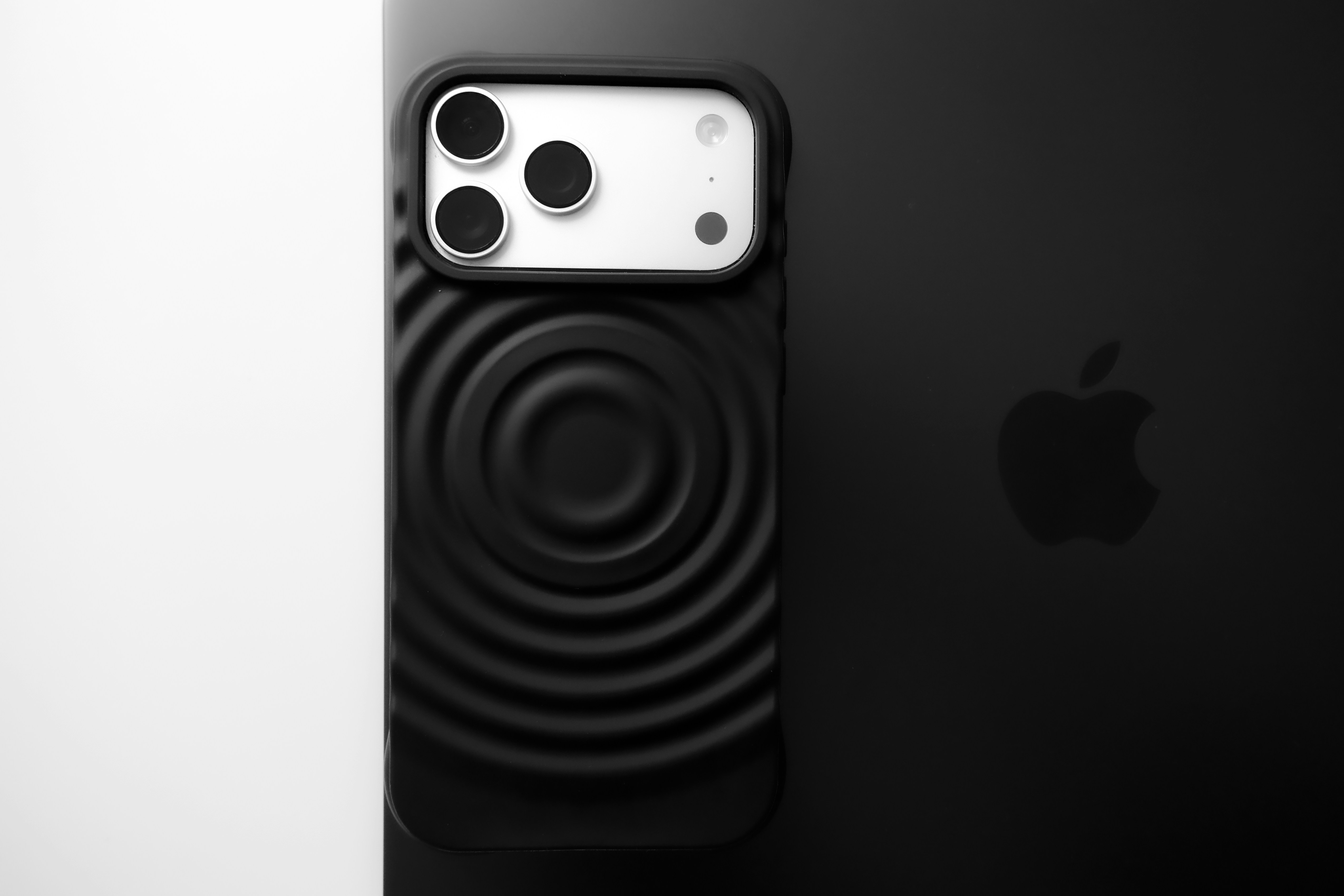 Black smartphone with textured case and apple logo.