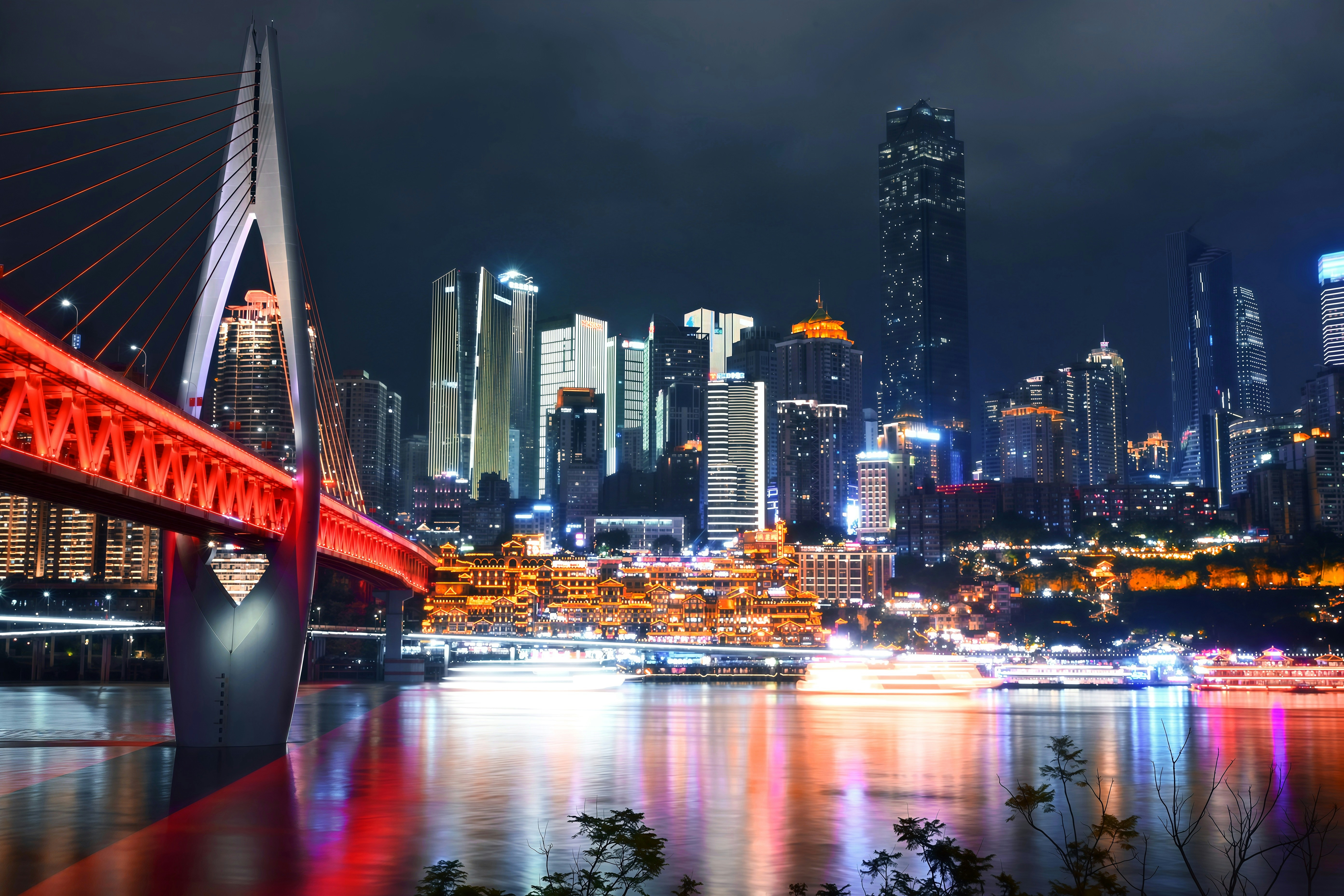 Modern cityscape with illuminated bridge at night