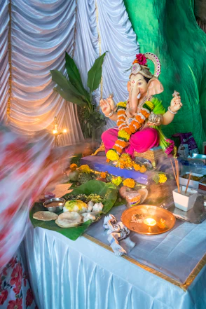 Ganesha idol decorated with flowers and offerings