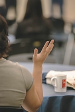 Woman raising hand in a meeting