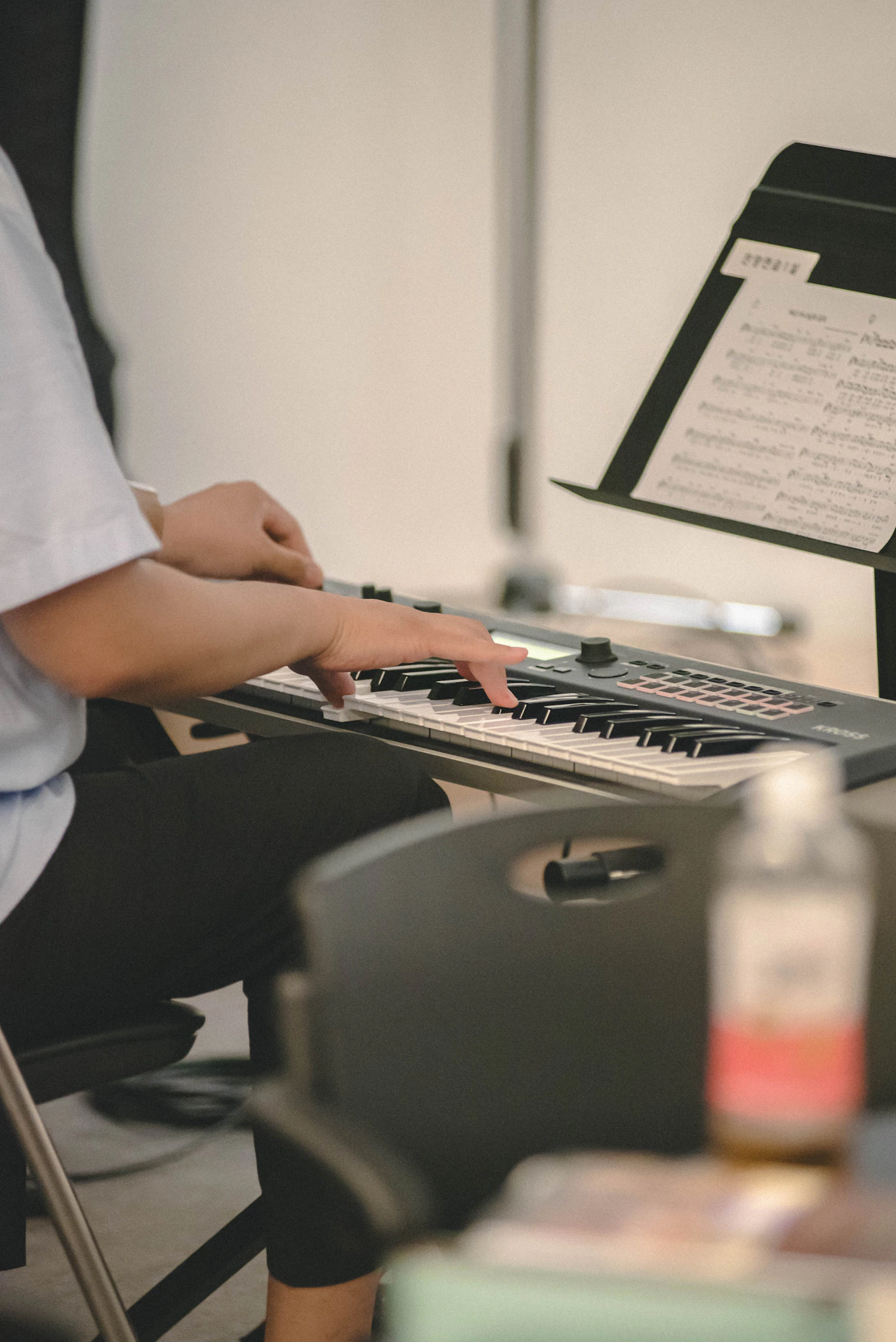 Musician playing a keyboard with sheet music