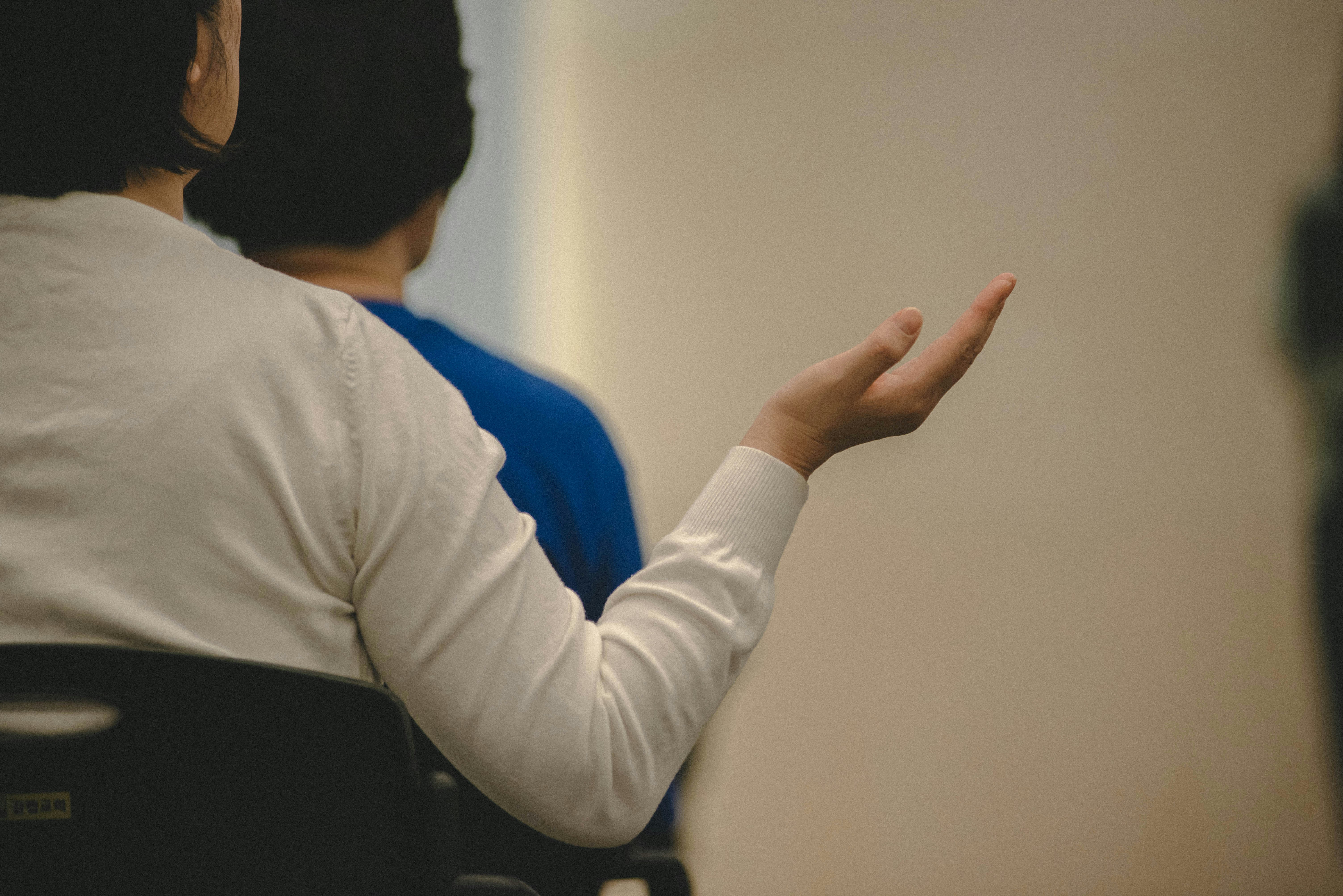 Woman gesturing with her hand in a meeting.