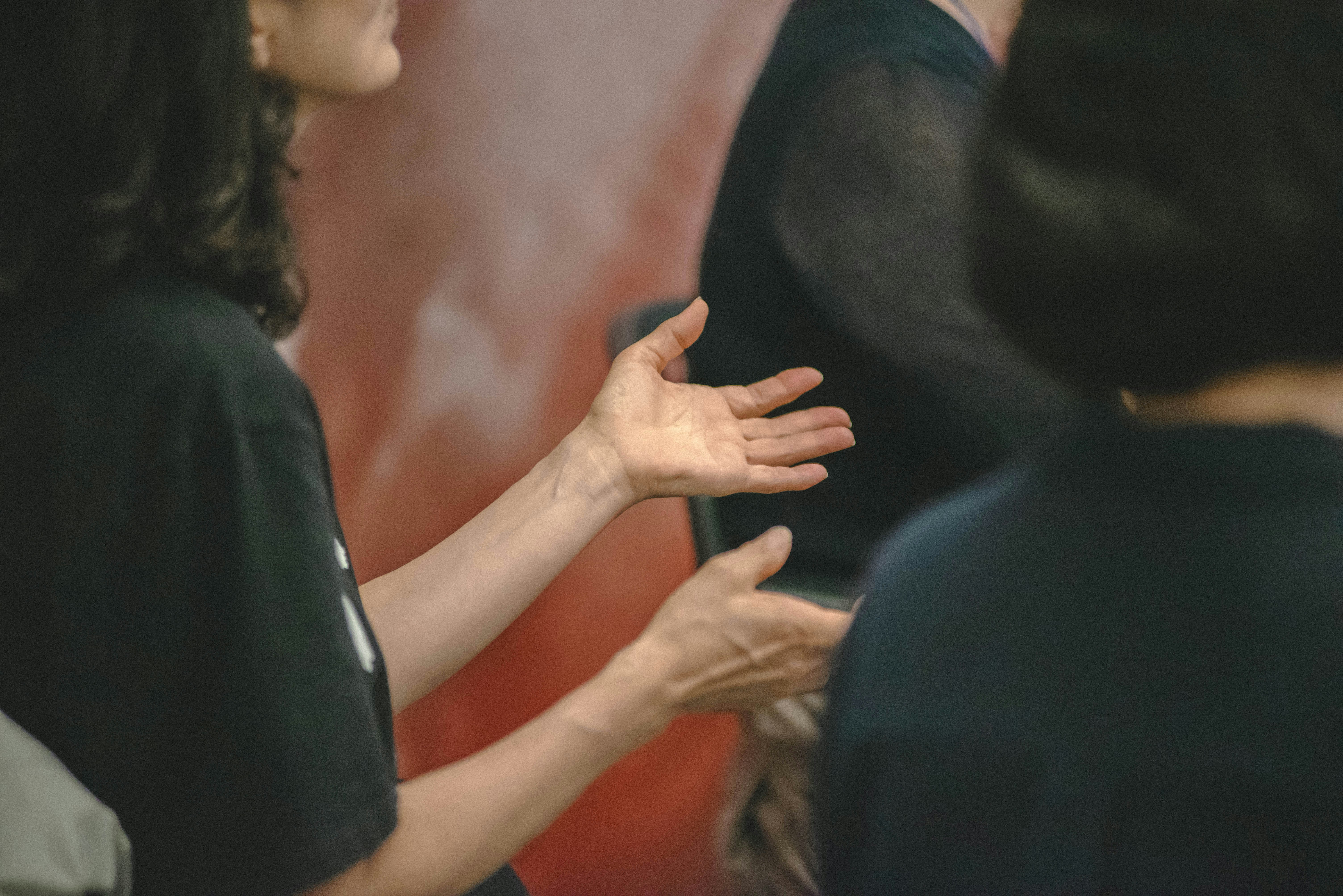 Woman gesturing with open hands during conversation